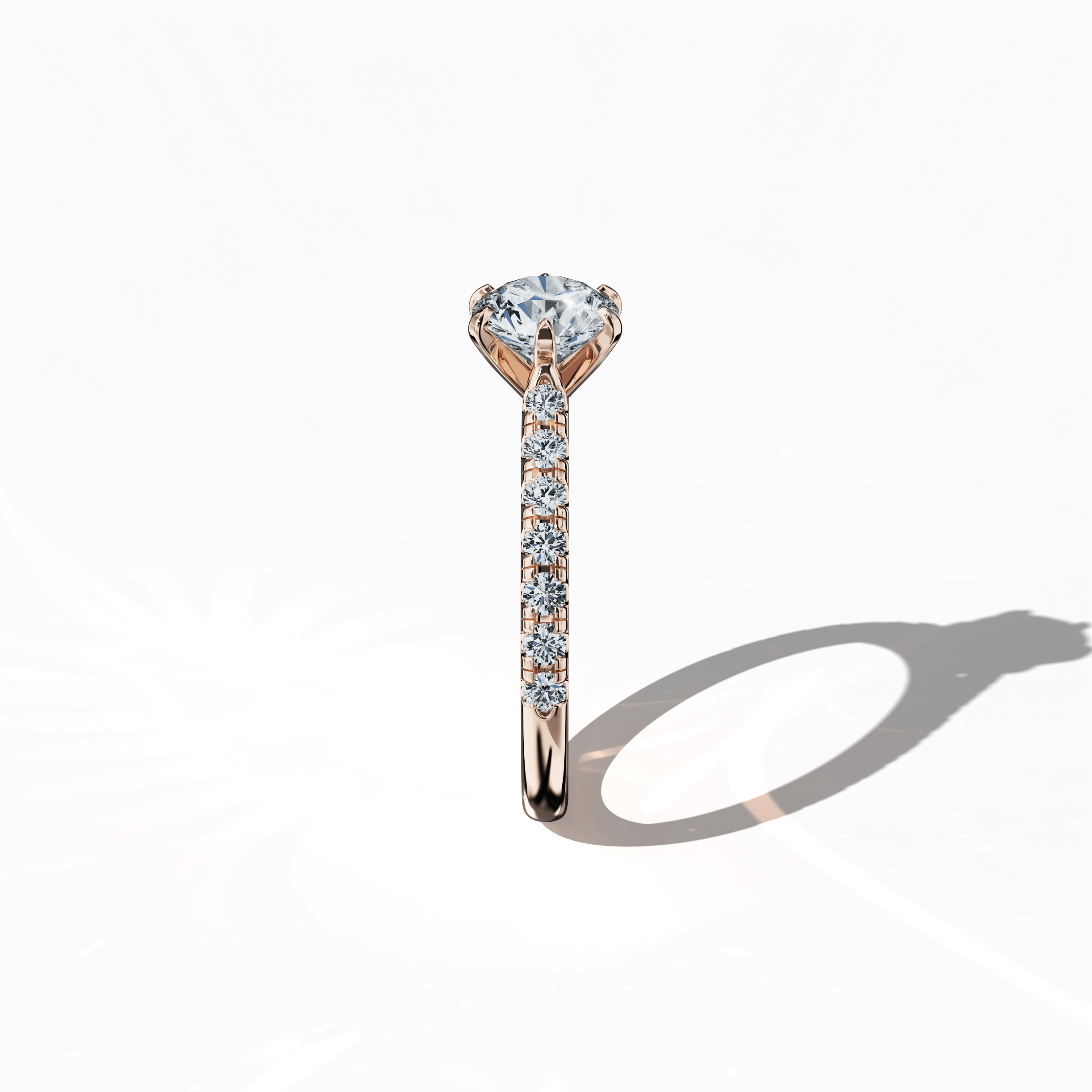 Side view of a розовое золото solitaire paved ring, showcasing a brilliant 1 карат center/centre diamond and 0.21 карат side diamonds along a refined slim band with a four nail prong setting. This perspective emphasizes the ring’s graceful profile and chic design, ideal as an engagement ring, wedding band, or fine Украшения/fine Ювелирные изделия accessory. Keywords: розовое золото, paved ring, diamond slim band, luxury, 1.21 карат, chic design.