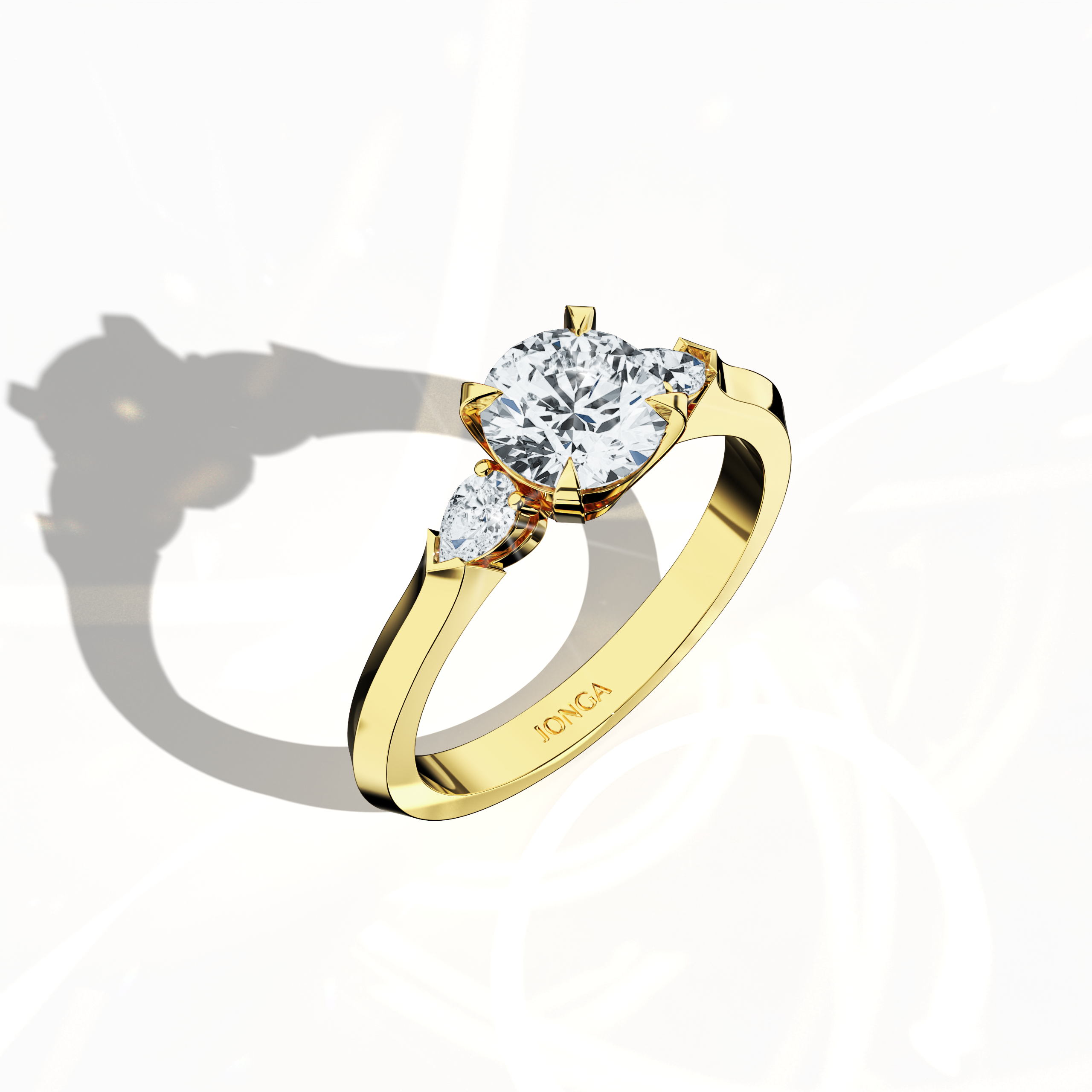 Front top side view of a yellow gold trio diamond ring displaying 1.30 ct natural diamonds—a 1 ct round center/centre diamond with two pear‐shaped side diamonds (0.30 ct total) in a slim band with a four‐nail prong setting. This dynamic angle reveals intricate detailing and balanced brilliance, ideal as an engagement ring, wedding band, or fine jewelry/fine jewellery piece. Also known as a trilogy ring, three‐stone ring, three‐diamond ring, trinity ring, and triptych ring design. Keywords: yellow gold.