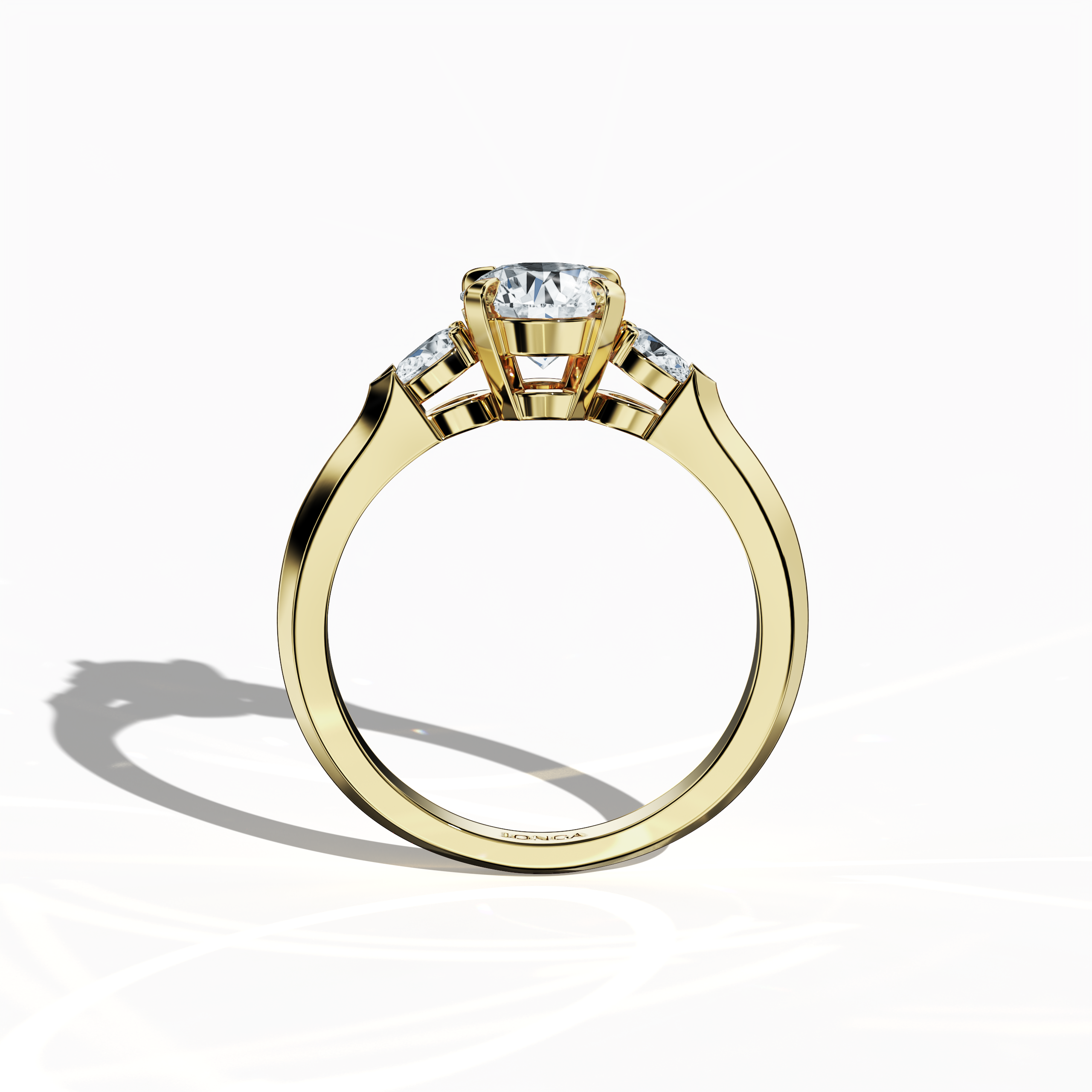 Standing front view of a yellow gold trio diamond ring featuring 1.30 ct natural diamonds with a 1 ct round center/centre diamond and two pear‐shaped side diamonds (0.30 ct total) in a slim band and four‐nail prong setting. Its vibrant sparkle and contemporary design make it ideal as an engagement ring, wedding band, or fine jewelry/fine jewellery piece. Also known as a trilogy ring, three‐stone ring, three‐diamond ring, trinity ring, and triptych ring design. Keywords: yellow gold, trio diamond ring.