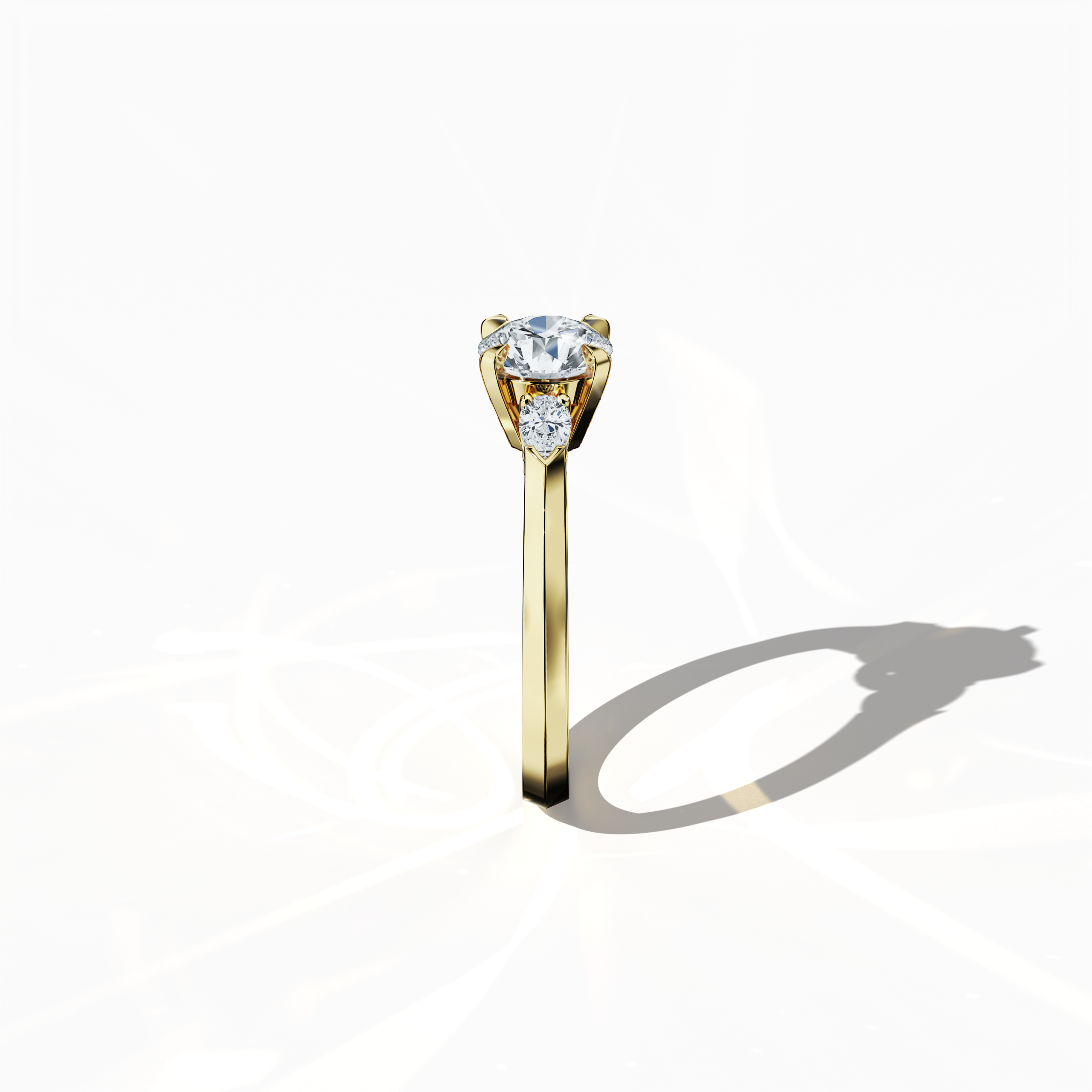 Side view of a yellow gold trio diamond ring highlighting 1.30 ct natural diamonds—a 1 ct round center/centre diamond flanked by two pear‐shaped side diamonds (0.30 ct total) in a refined slim band with a four‐nail prong setting. This profile accentuates its elegant silhouette and luminous finish as an engagement ring, wedding band, or fine jewelry/fine jewellery piece. Also known as a trilogy ring, three‐stone ring, three‐diamond ring, trinity ring, and triptych ring design. Keywords: yellow gold.
