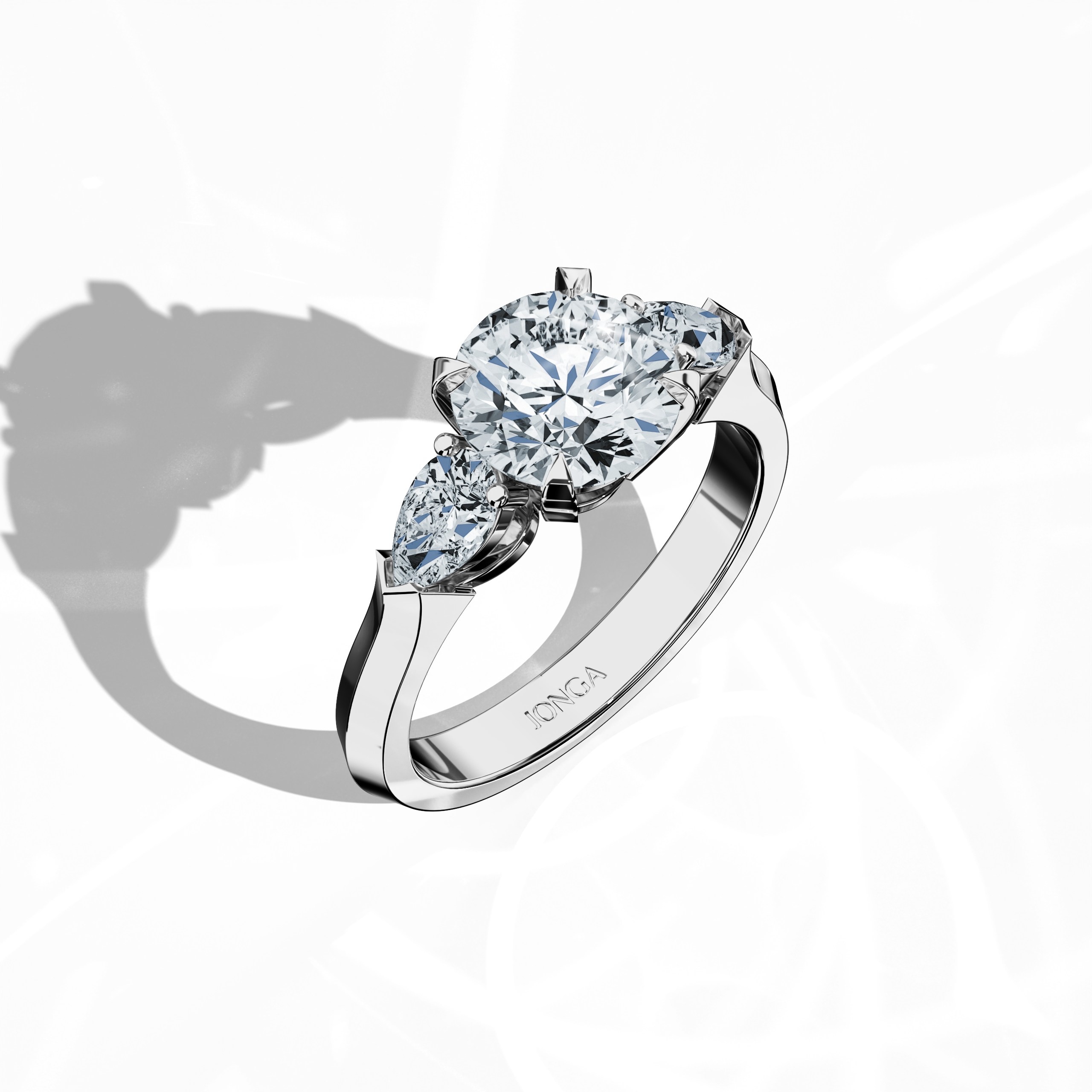 Front top side view of a white gold trilogy diamond ring displaying 2.55 ct natural diamonds—a 2 ct round center/centre diamond with two pear‐shaped side diamonds (0.55 ct total) set in an elegantly slim band with a four‐nail prong design. This dynamic angle reveals intricate detailing and balanced brilliance, ideal as an engagement ring, wedding band, or fine jewelry/fine jewellery piece. Also known as a trilogy ring, three‐stone ring, three‐diamond ring, trinity ring, and triptych ring design.