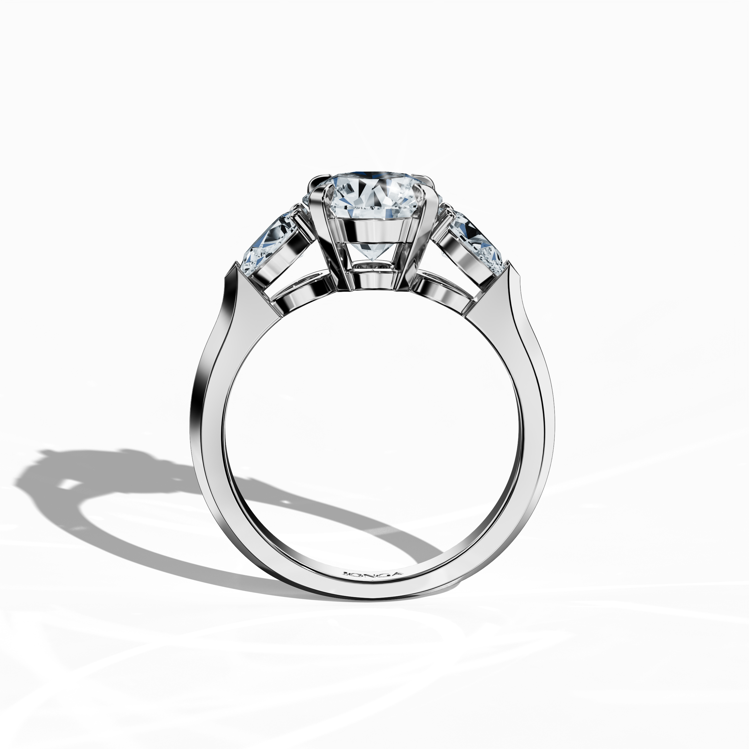 Standing front view of a white gold trilogy diamond ring featuring 2.55 ct natural diamonds, with a striking 2 ct round center/centre diamond flanked by two pear‐shaped side diamonds (0.55 ct total) in a sleek band and secure four‐nail prong setting. This design exudes modern sophistication as an engagement ring, wedding band, or fine jewelry/fine jewellery statement piece. Also known as a trilogy ring, three‐stone ring, three‐diamond ring, trinity ring, and triptych ring design. Keywords: white gold.