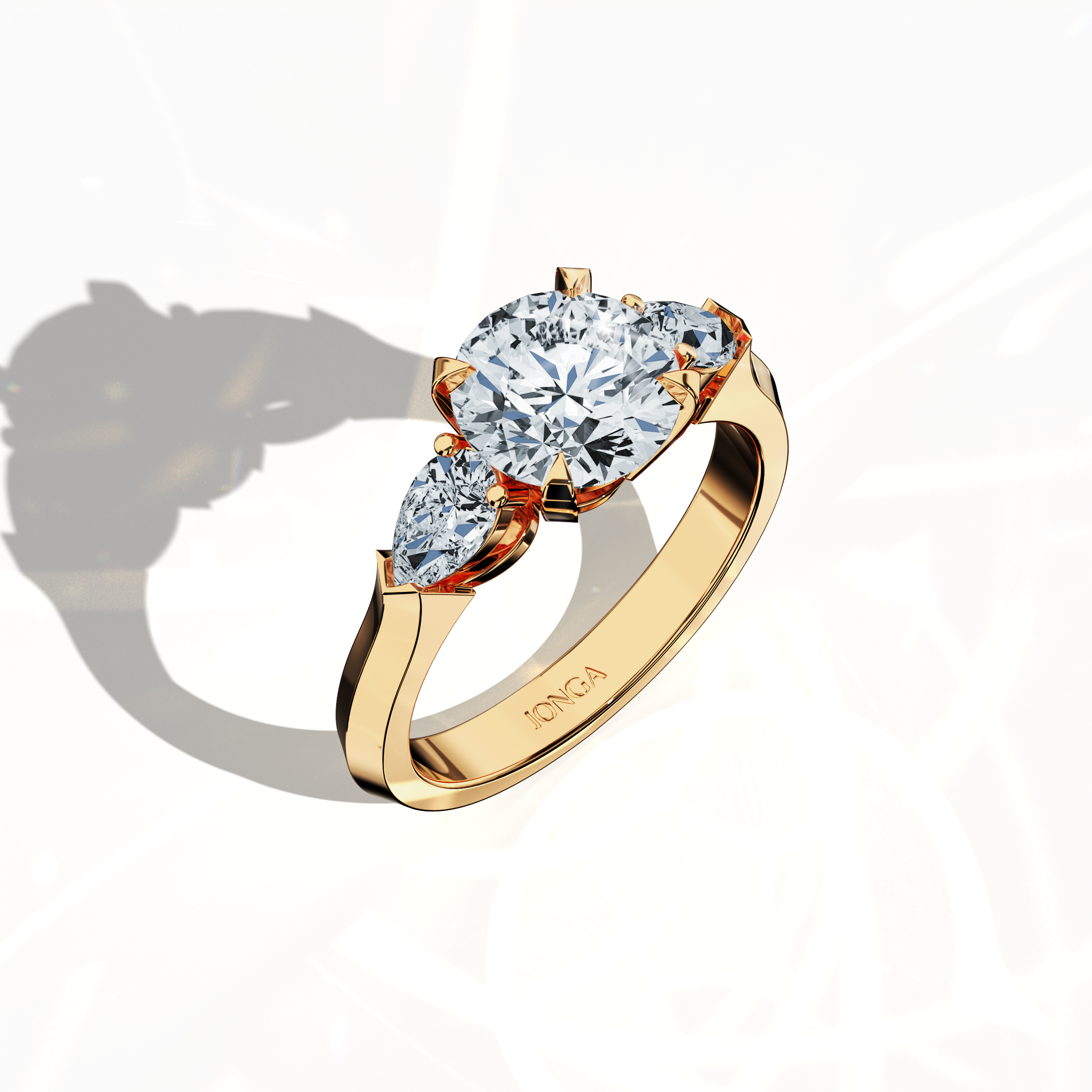 Front top side view of a yellow gold trilogy diamond ring displaying 2.55 ct natural diamonds—a 2 ct round center/centre diamond with two pear‐shaped side diamonds (0.55 ct total) set in an elegantly slim band with a four‐nail prong design. This dynamic angle reveals intricate detailing and balanced brilliance, ideal as an engagement ring, wedding band, or fine jewelry/fine jewellery piece. Also known as a trilogy ring, three‐stone ring, three‐diamond ring, trinity ring, and triptych ring design.