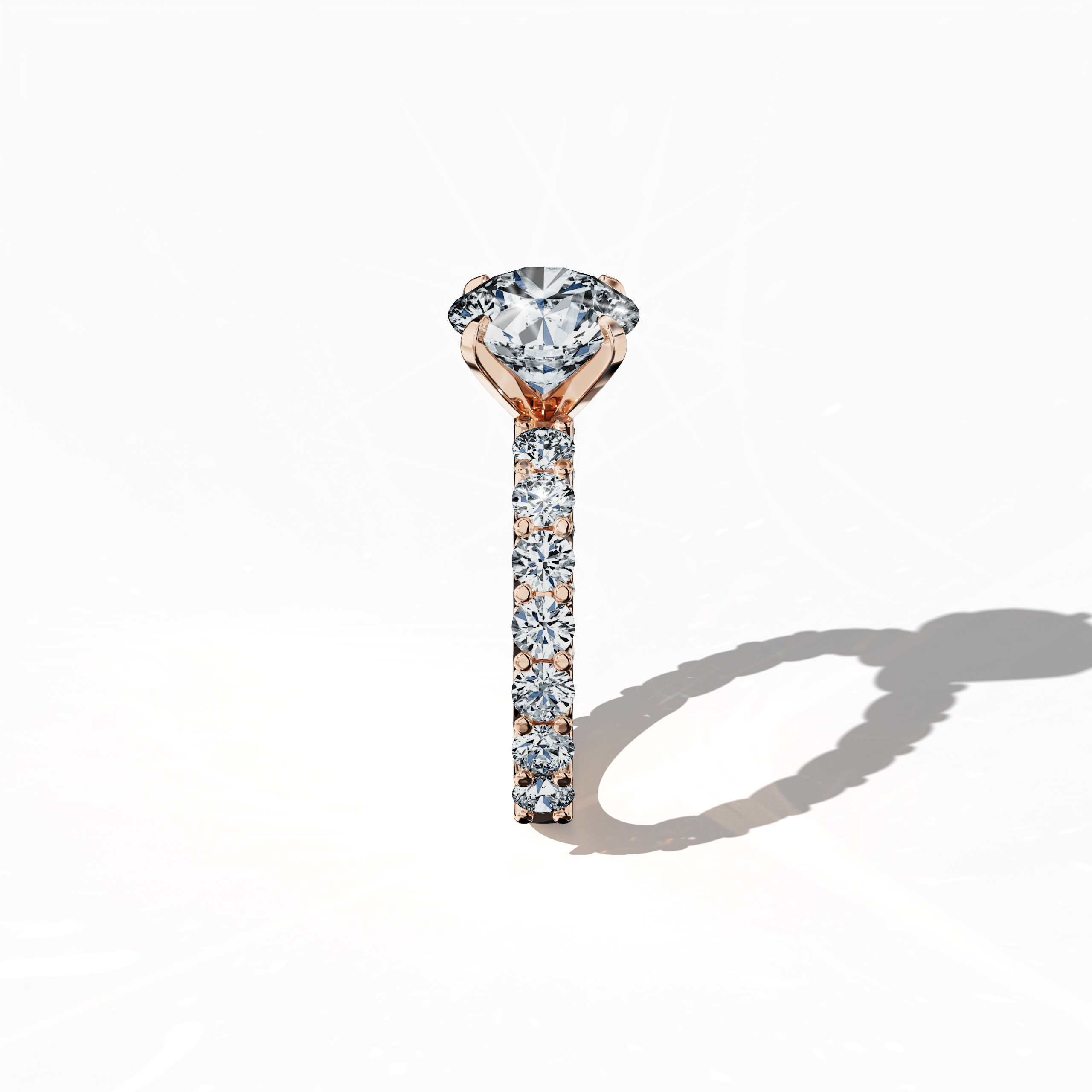 Side profile of a розовое золото solitaire Eternity ring with a stunning 3 карат center/centre diamond and 1.60 карат side diamonds, all set securely in a four-nail prong setting. This elegant side view emphasizes the sleek design and sparkling diamonds, making it a coveted piece for engagements, weddings, or anniversaries. Keywords: розовое золото, solitaire, diamond eternity band, luxury ring, wedding band, fine Ювелирные изделия, 4.60 карат, elegant side view.