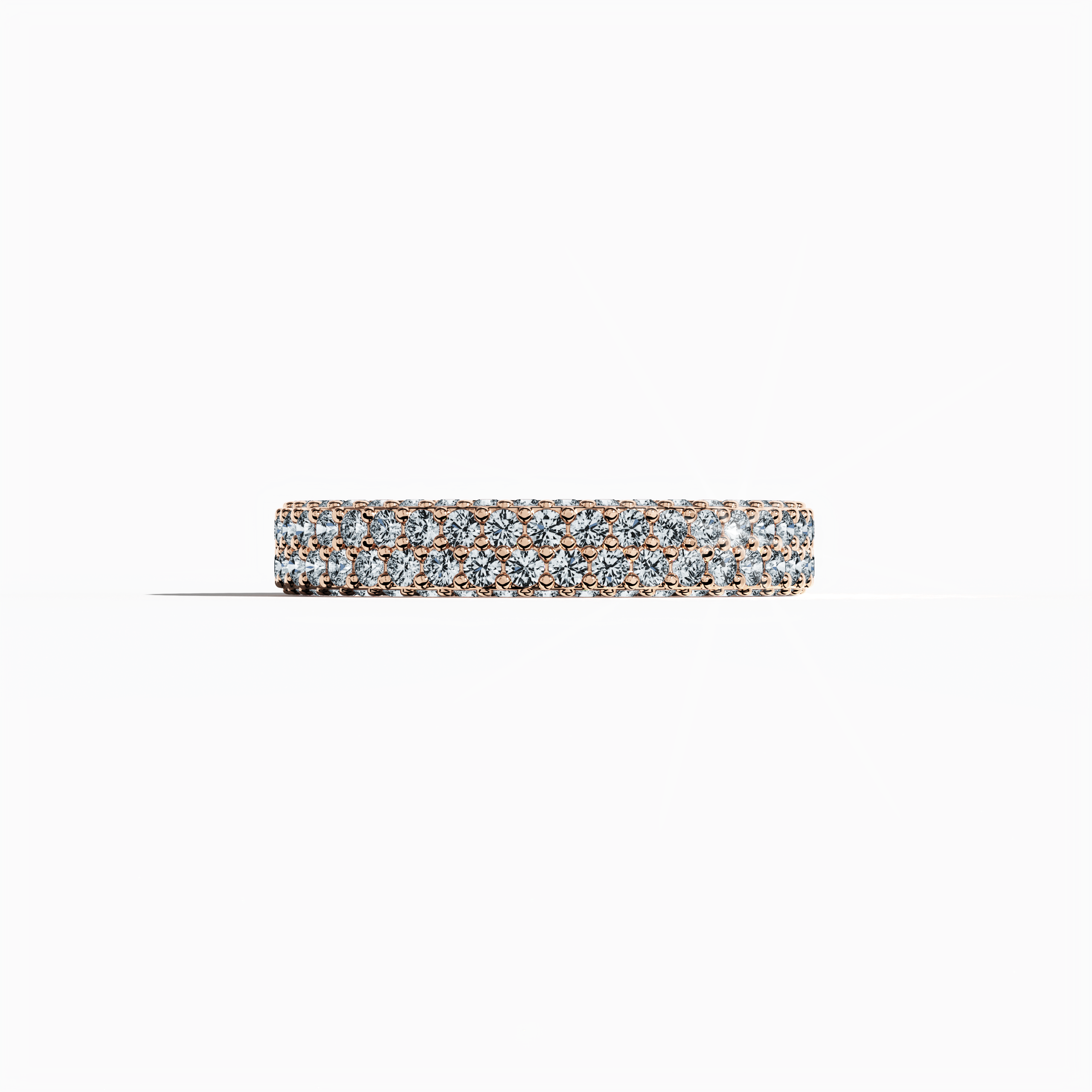 Elegant rose gold 4-row diamond band in a sleeping front view, displaying up to 2.10 carats of finely set micro diamonds. This exquisite design, recognized internationally as an eternity band, classic pave band, multi-row diamond band, and refined diamond band, boasts a warm blush gold finish with delicate engravings and smooth contours. The image captures soft reflections and intricate craftsmanship, epitomizing modern luxury and timeless charm. Keywords: rose gold, micro diamonds, elegance, luxury.