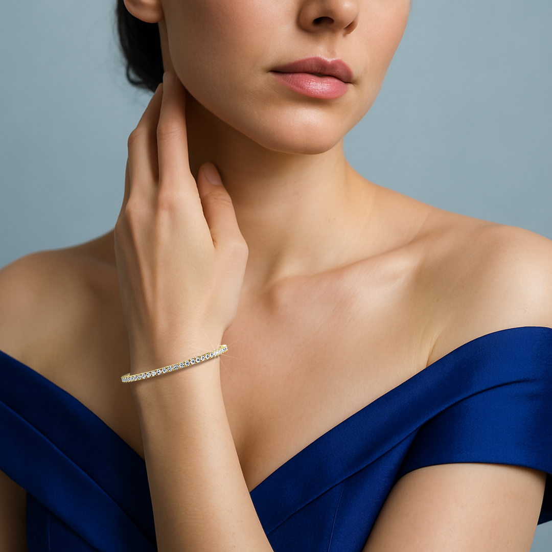 This 6-carat diamond tennis bracelet in yellow gold (sometimes labeled classic gold or champagne gold) is worn on a woman's wrist, illustrating its timeless charm and shimmering row of round diamonds. Known as a line bracelet, eternity bracelet, river bracelet, or inline bracelet, it offers both durability and elegance. A prong-set design ensures maximum brilliance, making it ideal for daily wear or formal events. Keywords: diamond tennis bracelet, yellow gold, line bracelet.