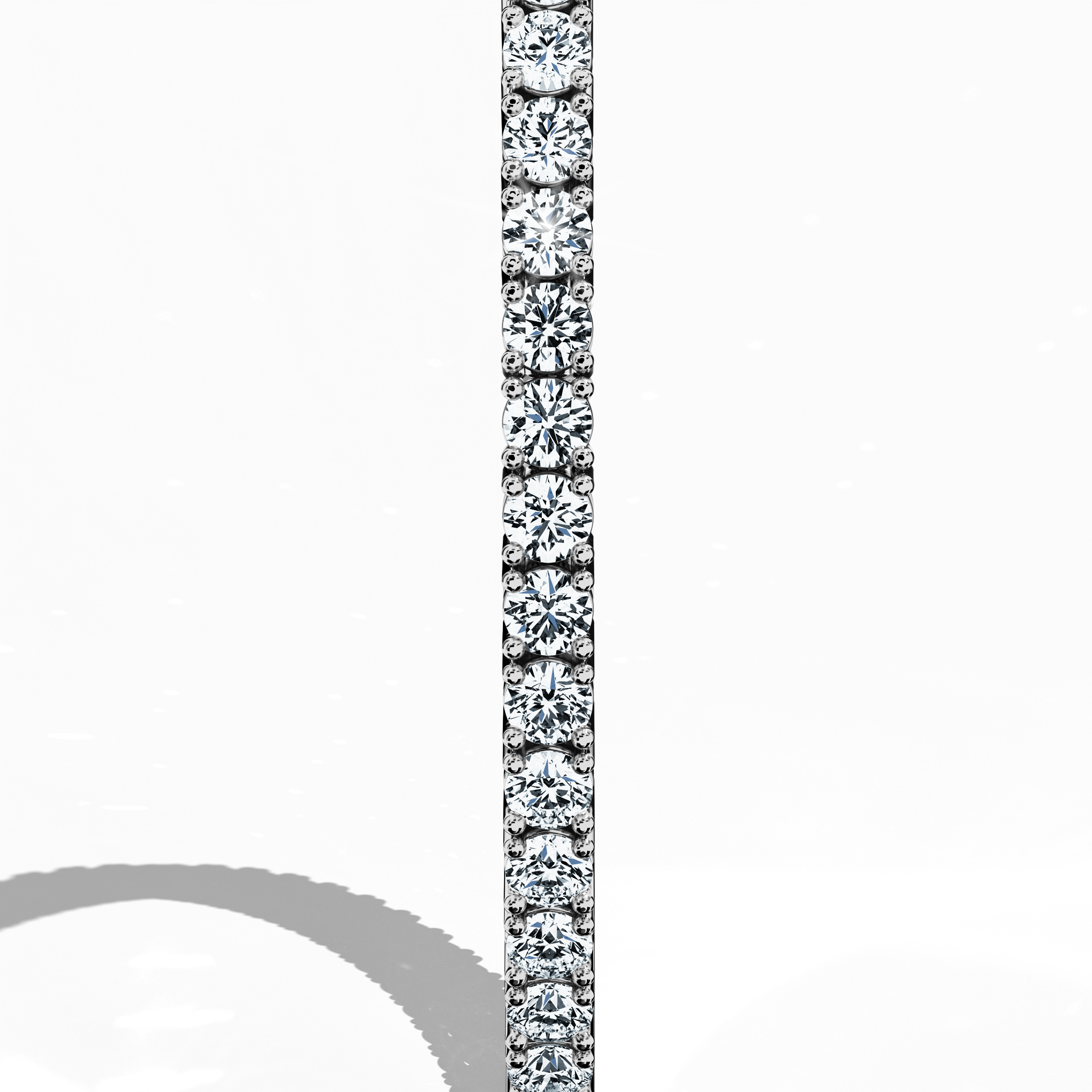 This 6-carat diamond tennis bracelet in белое золото (often called grey gold or palladium gold) is captured from a standing side perspective, revealing its fluid silhouette and continuous row of round diamonds. Also named a line bracelet, eternity bracelet, river bracelet, or inline bracelet, it features a secure clasp for daily wear. An icon of refined style, it shines for both casual and formal occasions. Keywords: diamond tennis bracelet, белое золото, line bracelet.