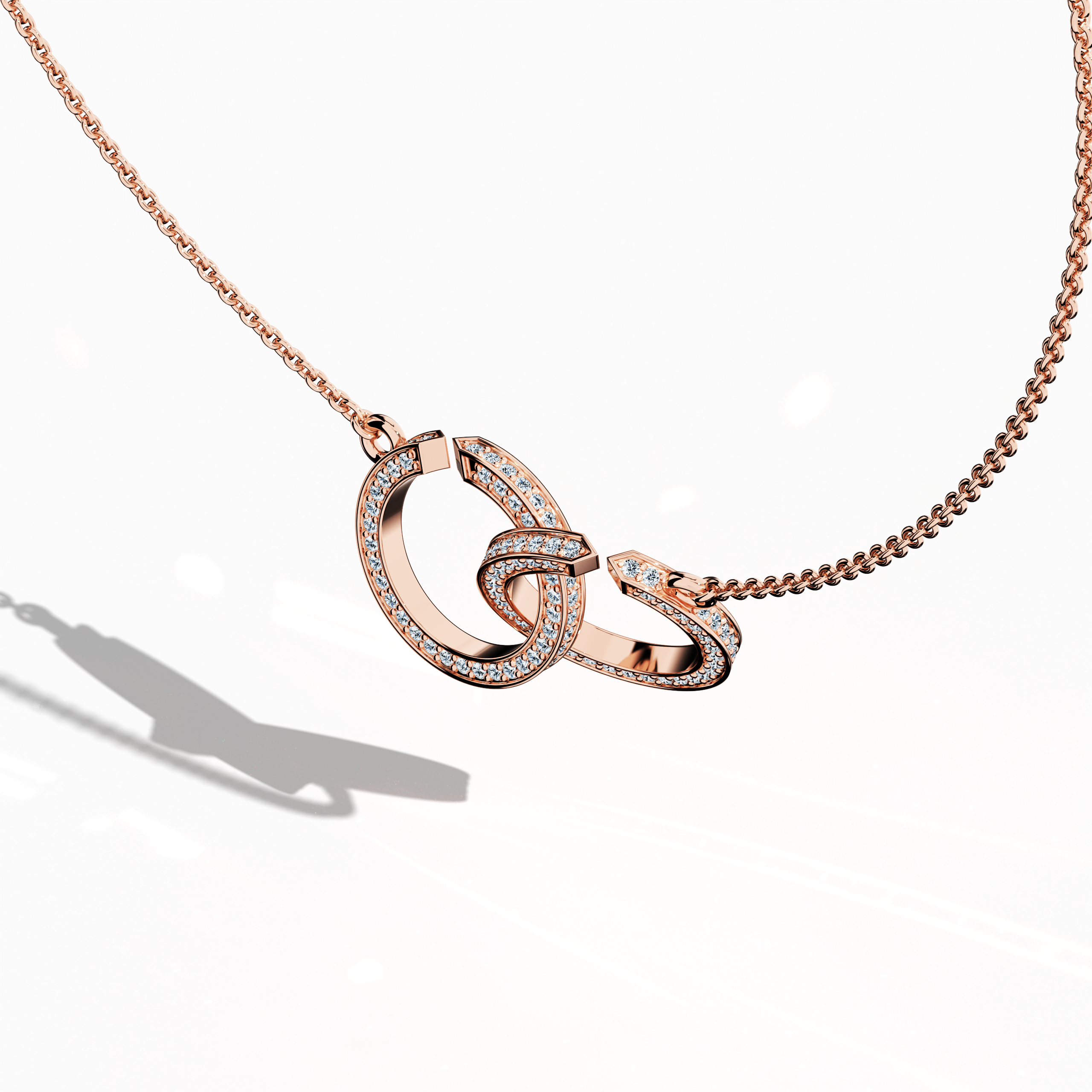 Angled front top side view of an interlock diamond pendant in розовое золото (oro rosa, or rose, Roségold), featuring a refined interlocking design accentuated by up to 0.90 carats of radiant diamonds. This elegant Украшения piece—recognized as an interlock pendant, diamond interlock necklace, or locked diamond pendant—combines intricate interlaced patterns with a graceful silhouette, while its warm blush hue and polished finish reflect modern luxury with timeless charm. Keywords: interlock diamond pendant.