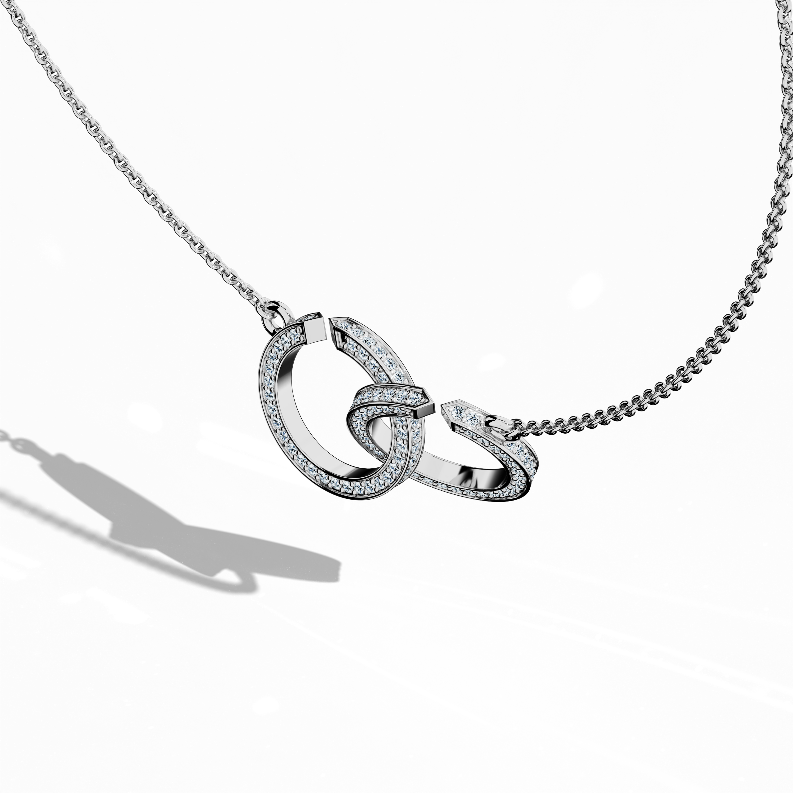 Angled top side view of a белое золото (oro blanco, or blanc, Weißgold) interlock бриллиант кулон, showcasing up to 0.90 carat бриллианты that accentuate its unique interlocked design. This sophisticated piece of jewelry (jewellery, joias, bijoux, gioielli, schmuck), also recognized as a бриллиант interlock колье or interlocked бриллиант кулон, merges contemporary style with classic appeal. Its reflective surface and precise detailing highlight expert craftsmanship. Keywords: interlock бриллиант кулон.