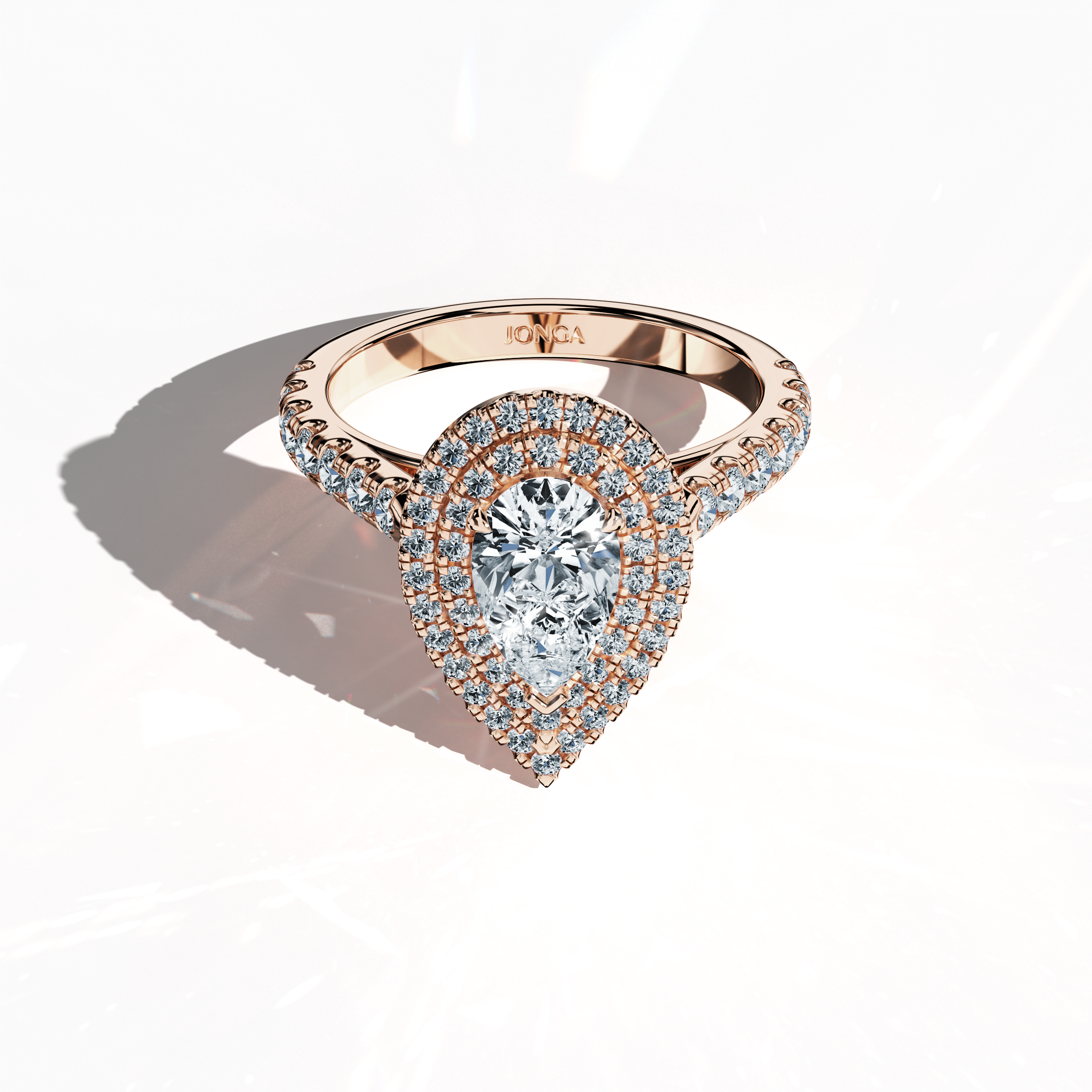Photograph presenting a stunning double halo diamond ring in alluring розовое золото (blush gold/romantic rose) from a sleeping front top view. The piece exhibits a 1ct pear‐cut center diamond (teardrop, waterdrop) surrounded by up to 1ct of sparkling side diamonds in a precise pave setting. Incorporating design elements like double halo, pavé halo, twin halo, cathedral halo, vintage halo, and contemporary halo, the image radiates sophisticated luxury, fine detailing, and global design influence.
