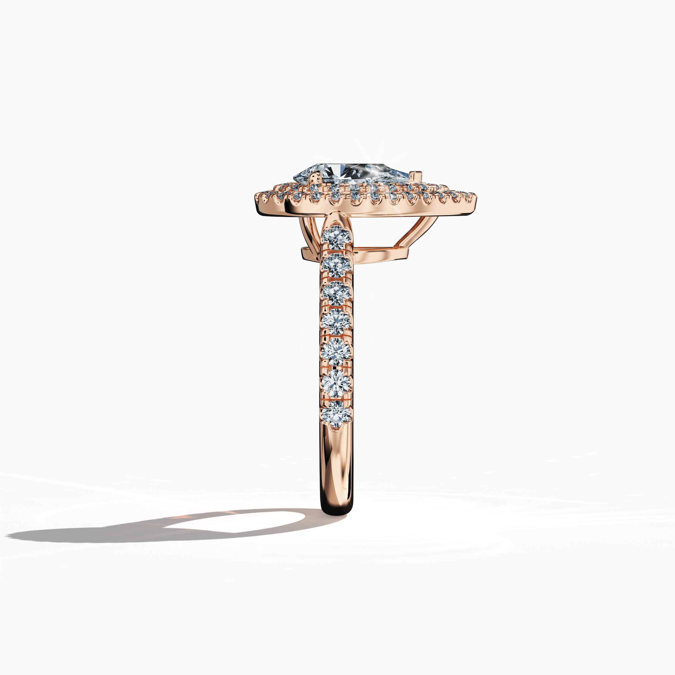 Detailed image displaying a side view of an elegant double halo diamond ring in enchanting rose gold (romantic rose/blush gold). The profile reveals a 1ct pear‐cut center diamond—alternatively termed teardrop or waterdrop—flanked by a meticulously paved halo of up to 1ct side diamonds. Showcasing design variations including double halo, pavé halo, twin halo, cathedral halo, vintage halo, and contemporary halo, this perspective emphasizes graceful contours, luxury, and international design sophistication.