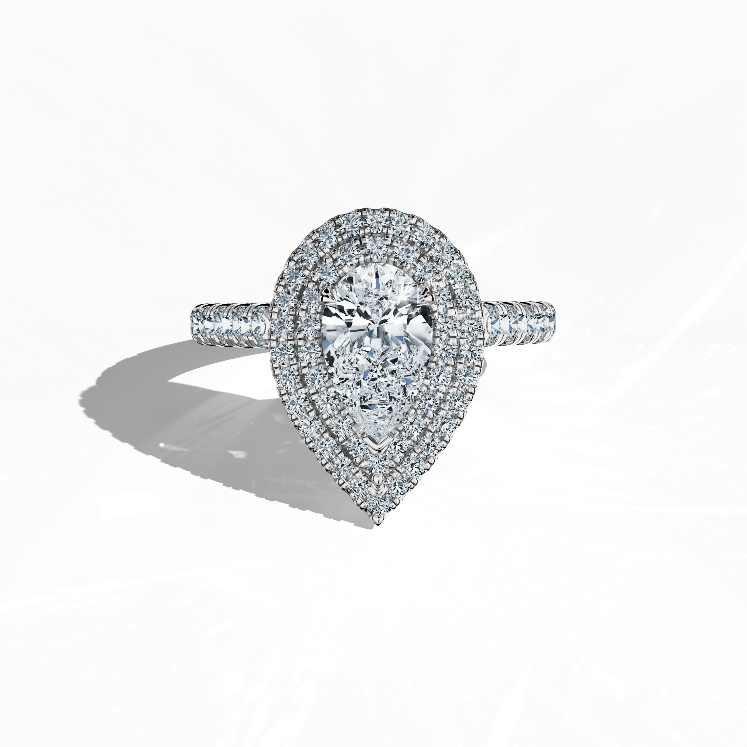 Image of a luxurious double halo diamond ring in radiant white gold (also known as sterling white or luminous white) displayed in a sleeping front view on a pristine surface. The ring features a dazzling 1ct pear‐cut center diamond—alternatively called teardrop or waterdrop—flanked by up to 1ct of meticulously paved side diamonds. Its design spans double halo, pavé halo, twin halo, cathedral halo, vintage halo, and contemporary halo styles, exuding refined craftsmanship, elegance, and international allure.