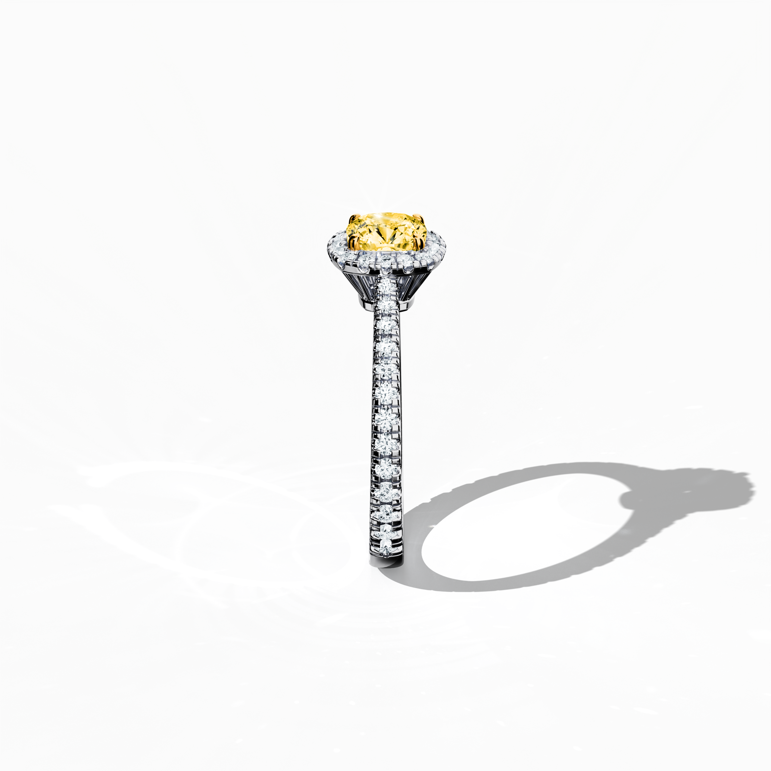 In a detailed standing side view, this halo paved ring in pristine white gold reveals a stunning 1ct yellow cushion‐cut diamond center embraced by a 0.60ct halo of shimmering side stones, totaling 1.60 carats. Marrying Classic Halo, Modern Halo, Vintage Halo, Contemporary Halo, and Eternity Halo aesthetics with inspirations from cushion and radiant diamond cuts, it incorporates alternate white gold terms such as silver-toned and frost-finished. Keywords: luxury, handcrafted, brilliance, sparkle, refined.