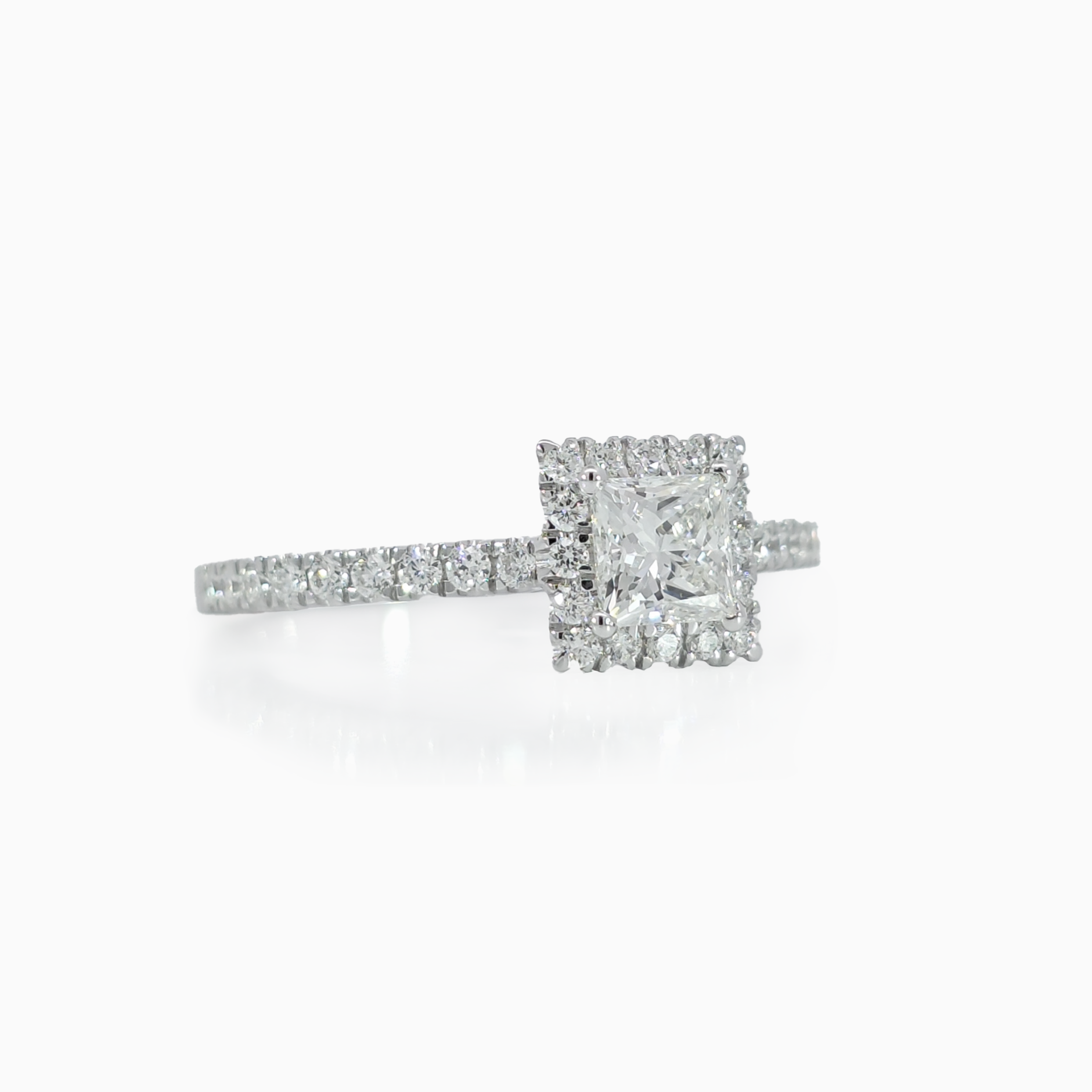 Halo Princess Ring showing 0.50 carat princess cut center diamond with halo setting in 18K white gold
