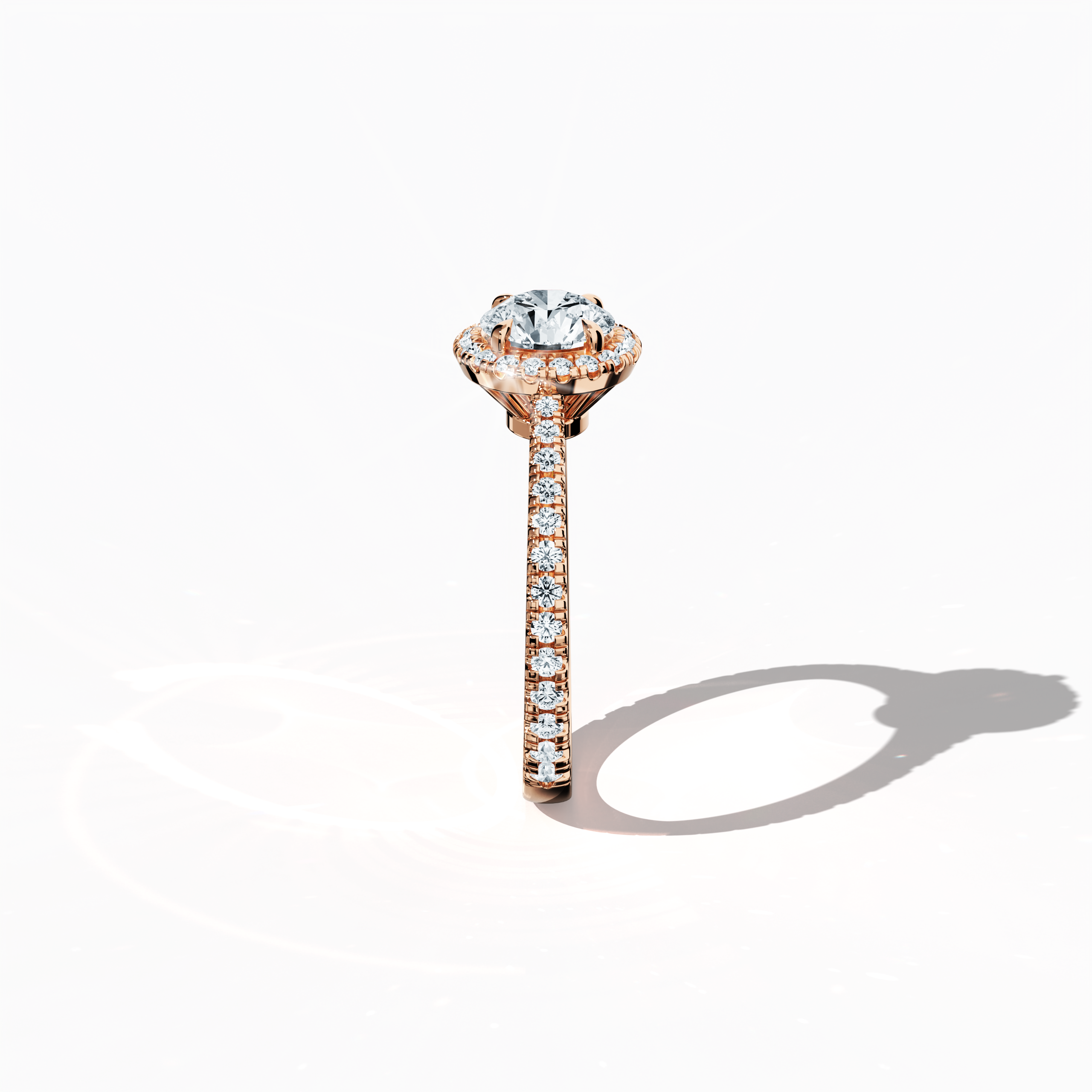 Detailed standing side view of a розовое золото halo paved ring accentuating its elegant profile and gracefully curved band featuring a 1ct round‐cut center diamond paired with a 0.60ct side diamond halo. The lateral angle reveals intricate pavé details in warm rose, pink, and blush gold, blending influences of classic halo, vintage halo, modern halo, and bridal halo designs. Keywords: refined, round brilliance, artisanal, luxury, contemporary style.