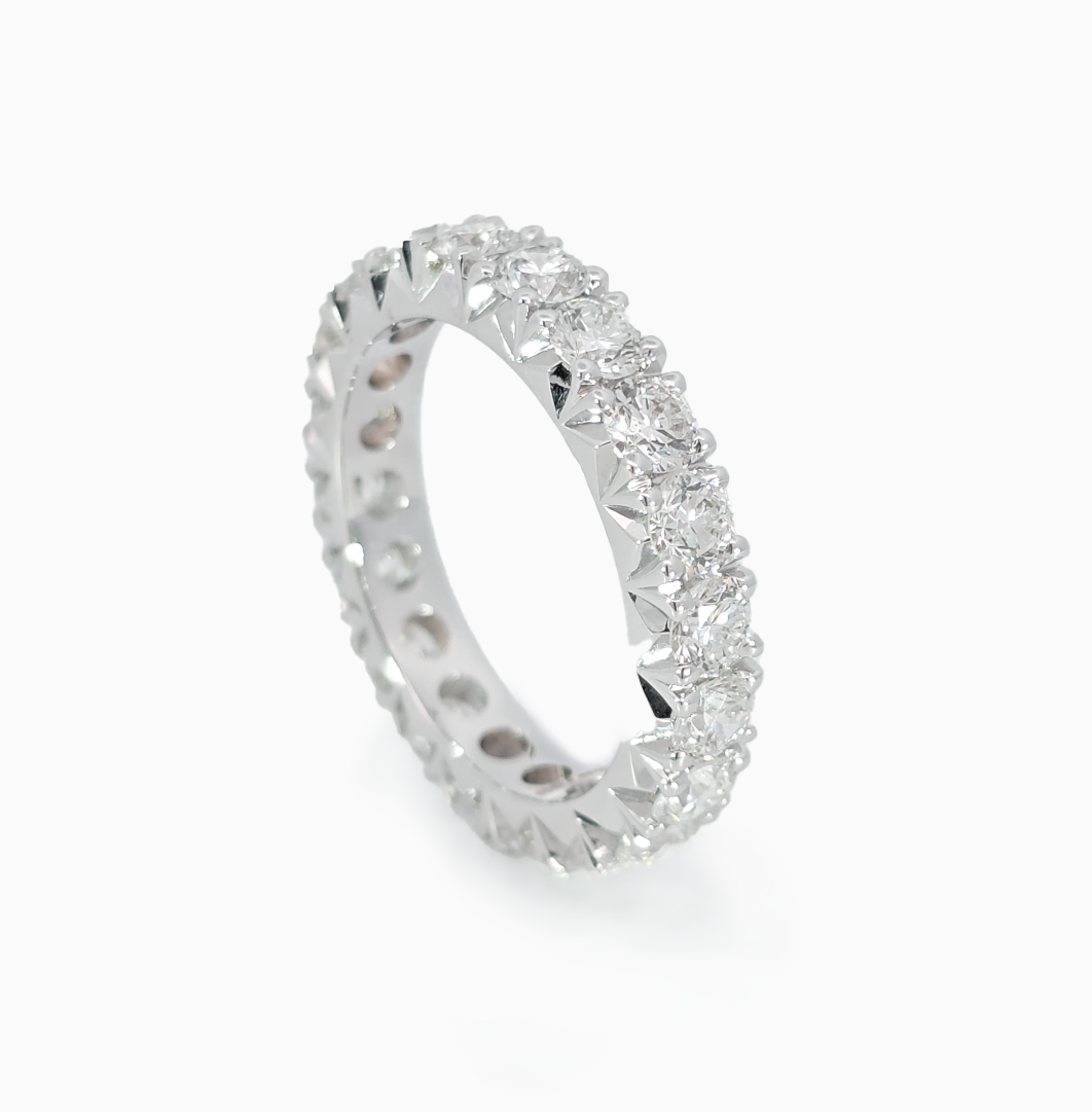 Round Eternity Band showing fishtail setting with 2.58 carat D-F color VVS-VS clarity diamonds by Jonga
