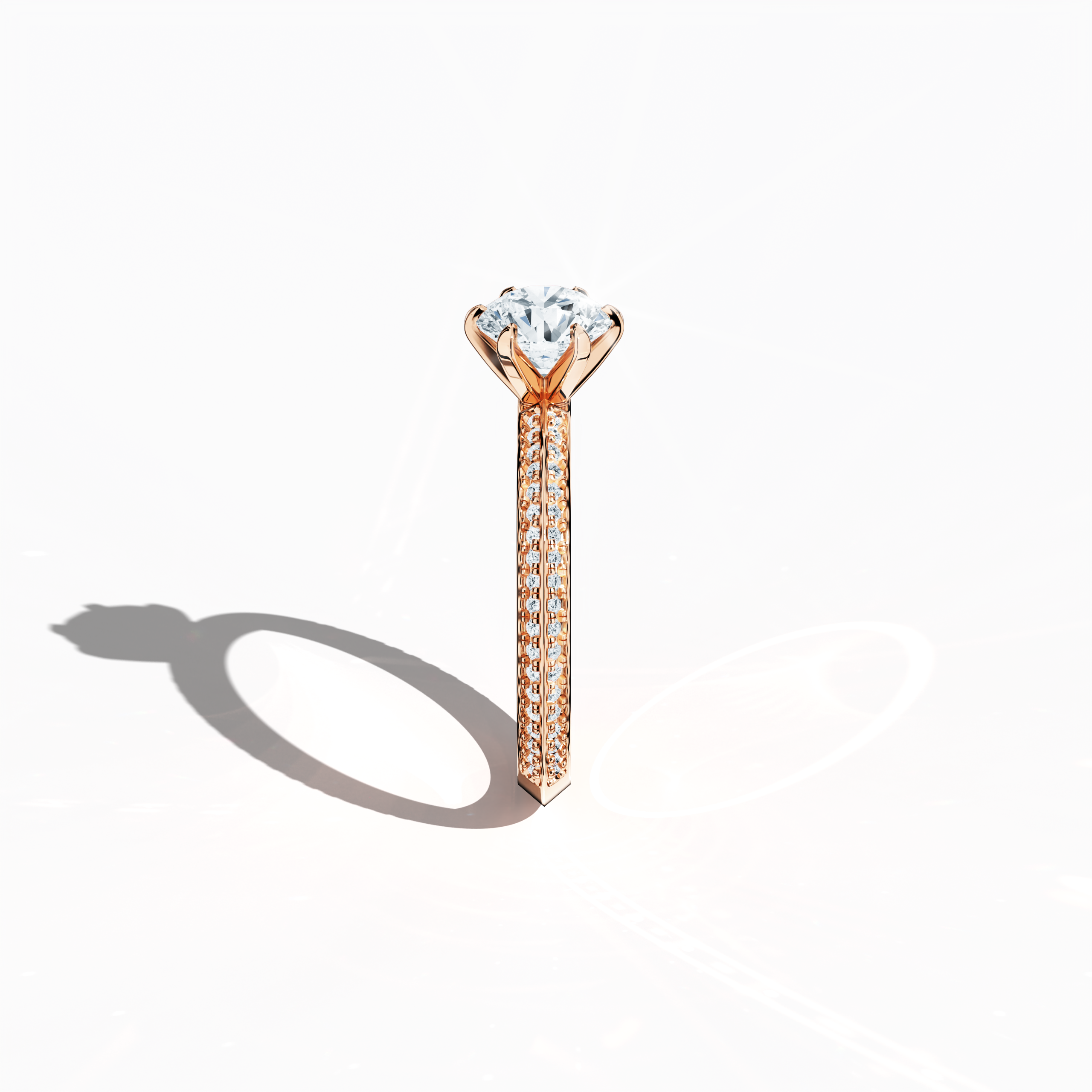 Refined solitaire paved ring with 1.40 ct diamonds – a 1 ct center diamond and 0.40 ct pavé side stones – set in soft rose gold (blush/pink gold) with a two‑step band featuring a sharp central accent. Photographed from a standing side view, this fine jewelry/fine jewellery ring showcases elegant contours and warm, romantic allure.