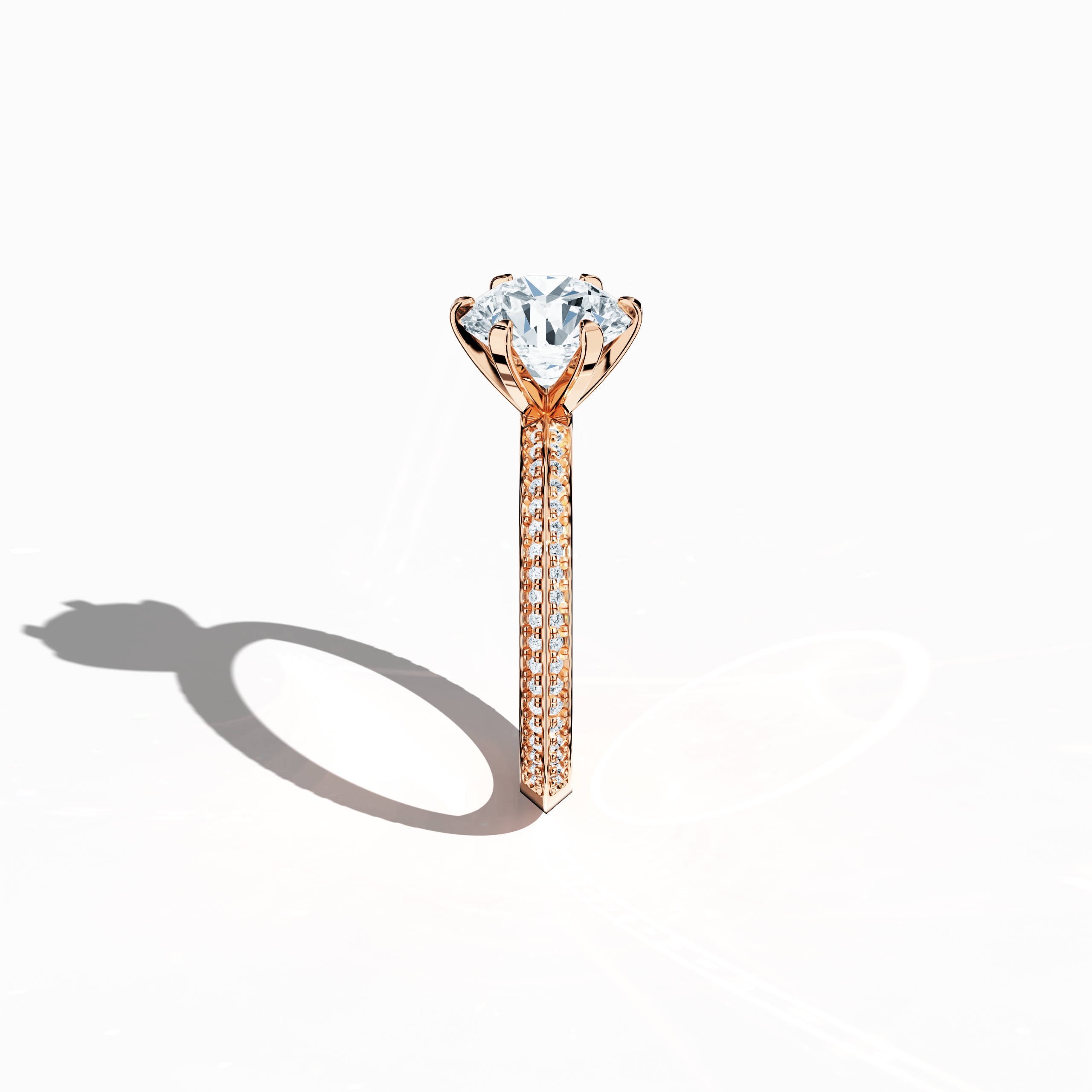 Refined solitaire paved ring with 2.40 ct total diamonds (2 ct center, 0.40 ct side stones) in a six‑prong setting and a two‑step band with a sharp central line, set in soft rose gold (blush/pink gold). Photographed from a standing side view, this fine jewelry/fine jewellery ring showcases its elegant contours and warm, romantic allure.