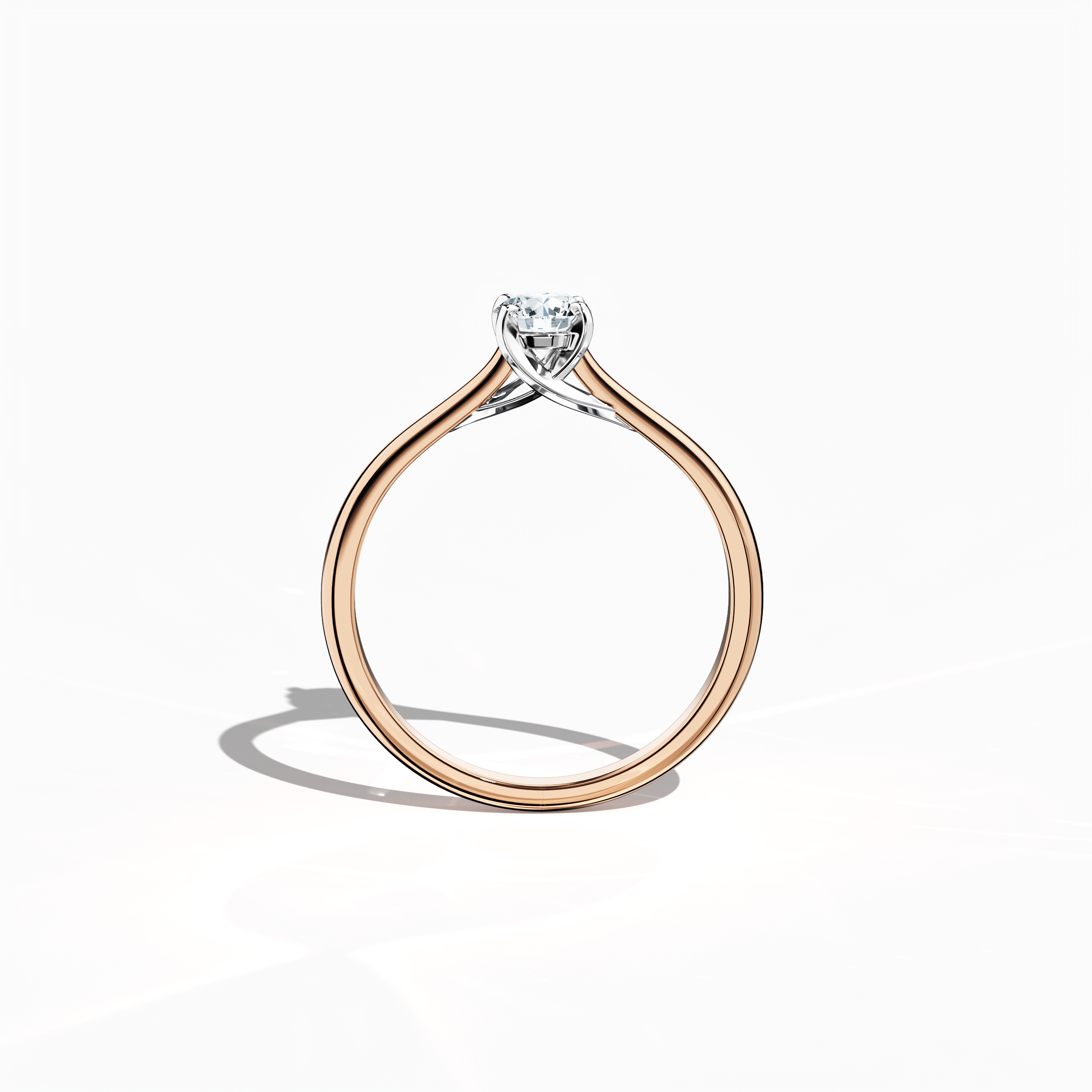Refined solitaire diamond ring with a 0.30  карат center stone in a unique twisted bottom setting, secured by four‑tap prongs in белое золото and paired with a soft розовое золото band (blush/pink gold). Shown from a standing front view, this fine Украшения/fine Ювелирные изделия ring exemplifies modern romance and sophisticated design.