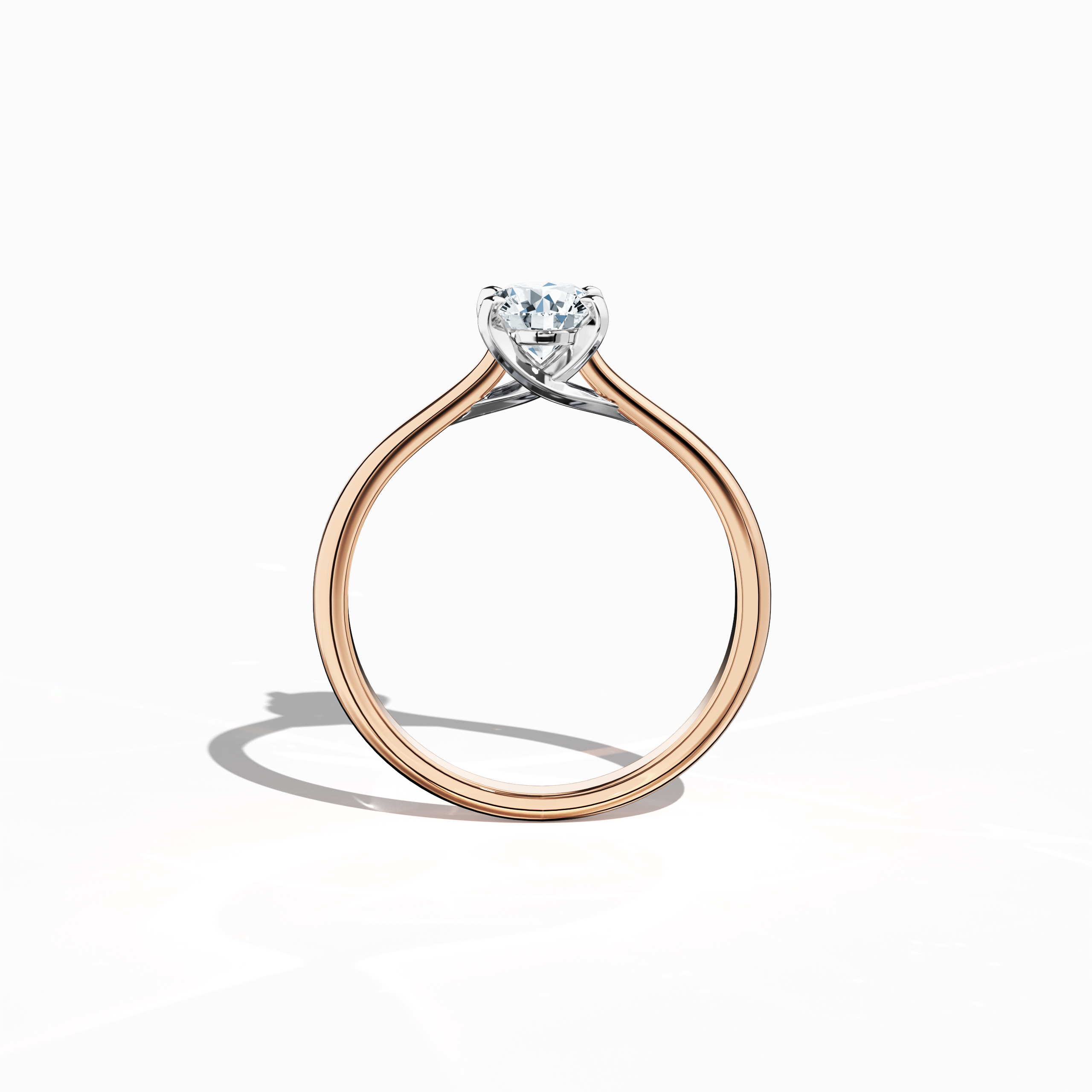 Refined solitaire diamond ring with a 0.70  карат center stone in a unique twisted bottom design and four‑tap prongs in белое золото, paired with a soft розовое золото band (blush/pink gold). Shown from a standing front view, this fine Украшения/fine Ювелирные изделия ring exemplifies modern romance and sophisticated style.