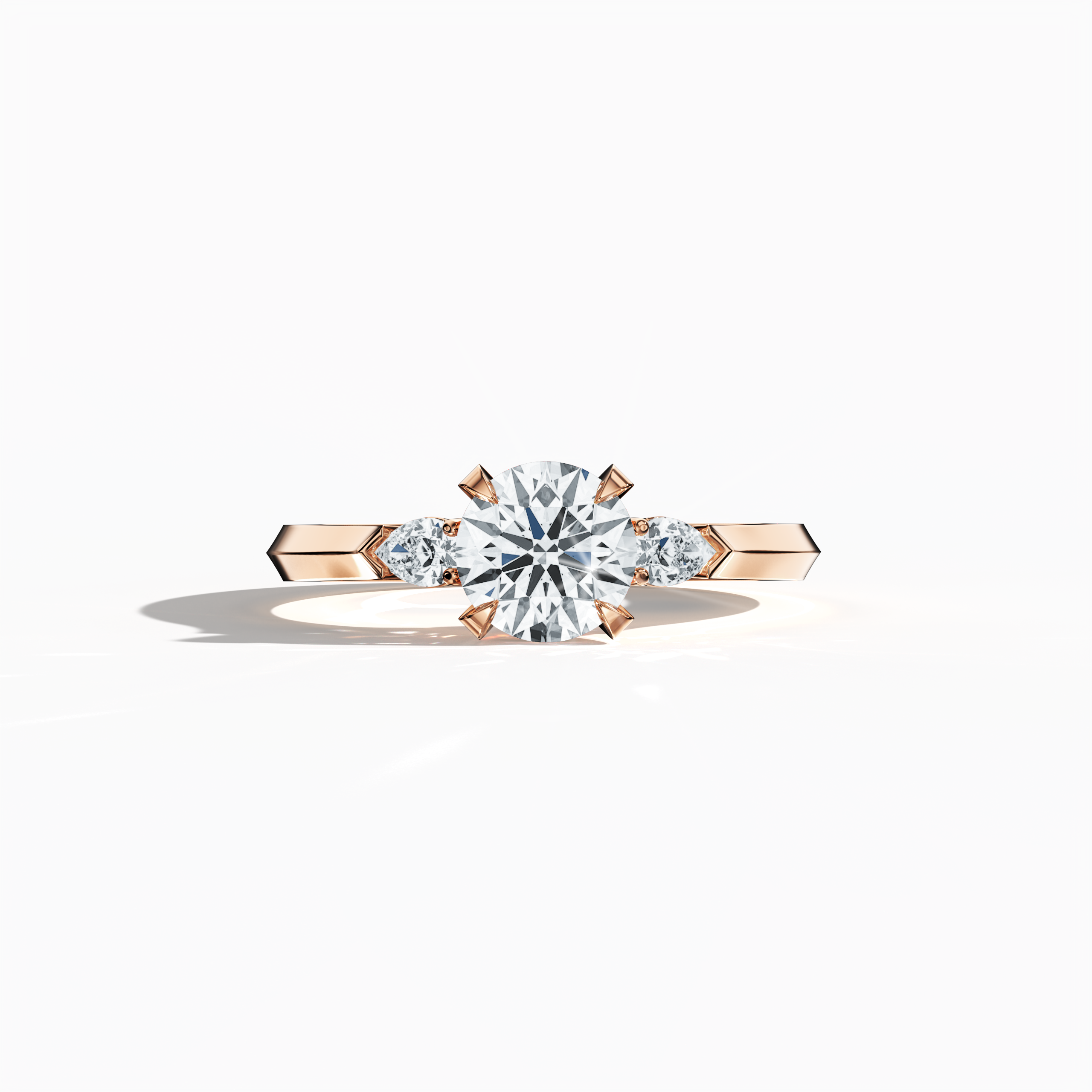 Rose gold trio diamond ring with 1.30 ct natural diamonds—a 1 ct round center/centre diamond and two pear‐shaped side diamonds (0.30 ct total). Captured in a sleeping front view, its warm blush tone and refined four‐nail prong setting create an elegant look as an engagement ring, wedding band, or fine jewelry/fine jewellery piece. Also known as a trilogy ring, three‐stone ring, three‐diamond ring, trinity ring, and triptych ring design. Keywords: rose gold, trio diamond ring, elegant.