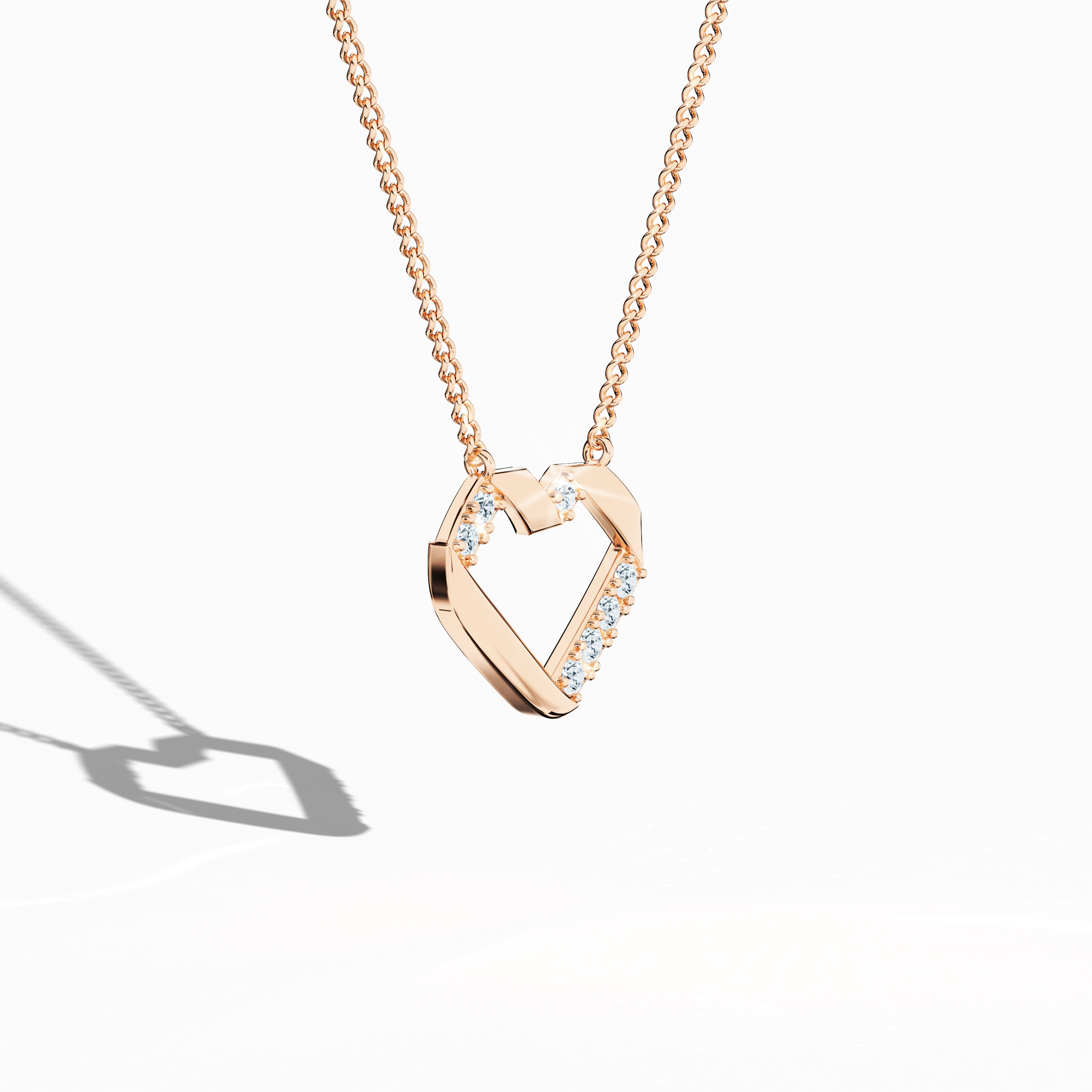 Angled top perspective of a rose gold (oro rosa, or rose, Roségold) diamond heart-pendant showcasing up to 0.28 carat diamonds. This stylish piece of jewelry (jewellery, joias, bijoux, gioielli, schmuck), identified as a diamond heart necklace, diamond love pendant, collier cœur diamant, colgante de corazón con diamantes, pendentif cœur diamant, collana cuore di diamanti, or Halskette Herz mit Diamant, boasts a warm blush tone and elegant open-heart shape. Keywords: diamond heart-pendant, rose gold.