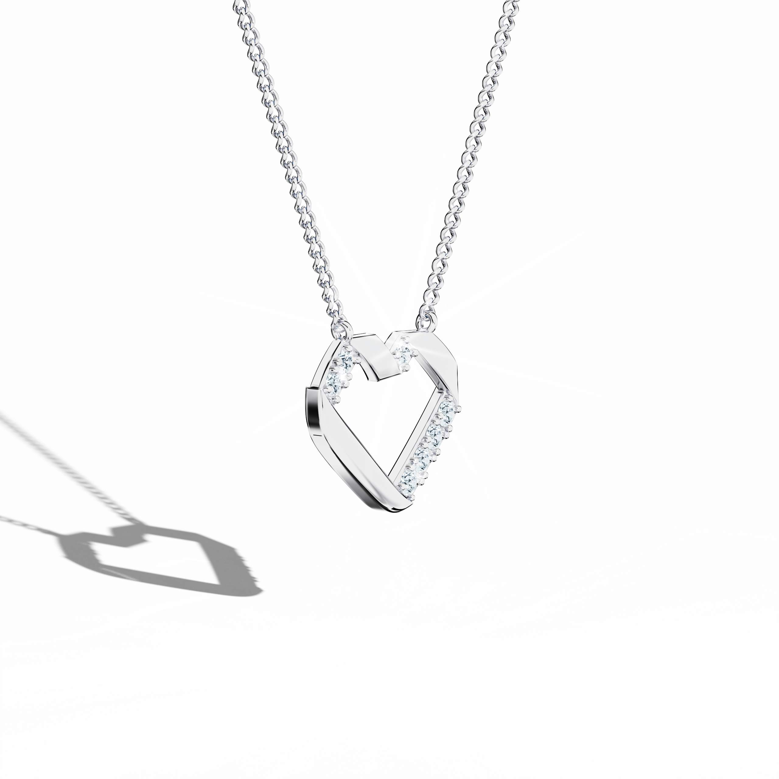 Angled top perspective of a white gold (oro blanco, or blanc, Weißgold) diamond heart-pendant adorned with up to 0.28 carat diamonds. This modern piece of jewelry (jewellery, joias, bijoux, gioielli, schmuck), also known as a diamond heart necklace, diamond love pendant, collier cœur diamant, colgante de corazón con diamantes, pendentif cœur diamant, collana cuore di diamanti, or Halskette Herz mit Diamant, highlights a refined silhouette and sparkling brilliance. Keywords: diamond heart-pendant, white gold