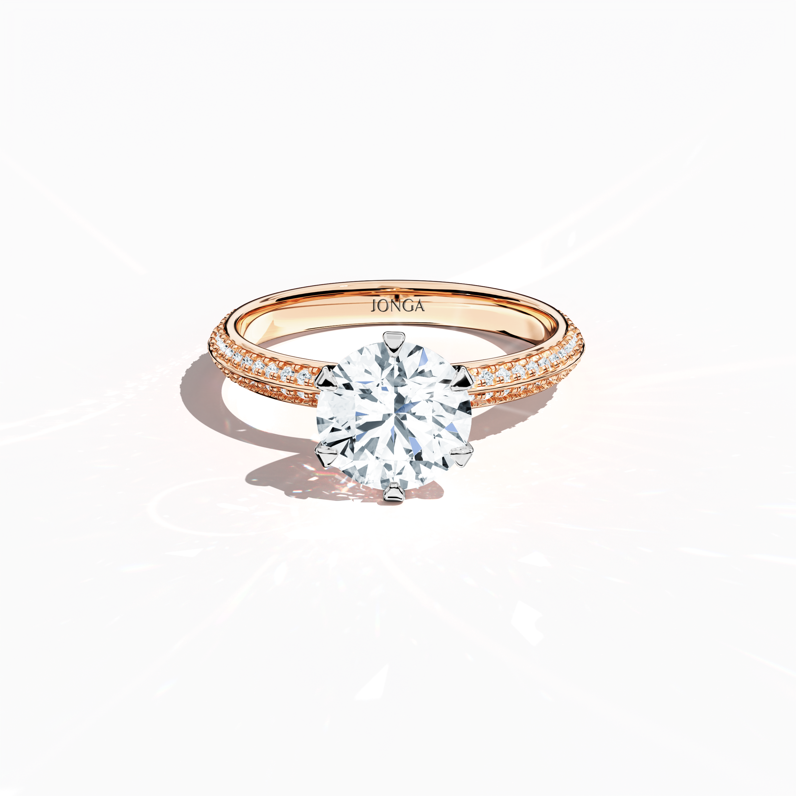 Elegant 2.40  карат diamond ring in a six‑prong setting with a pavé band—comprising a 2  карат center stone and 0.40  карат side stones—rendered in soft розовое золото (blush/pink gold) with a dual‑tier, step‑accented band and a defined central line. Captured from a front top view, this fine Украшения/fine Ювелирные изделия ring highlights its luminous pavé detailing and gentle, romantic finish.