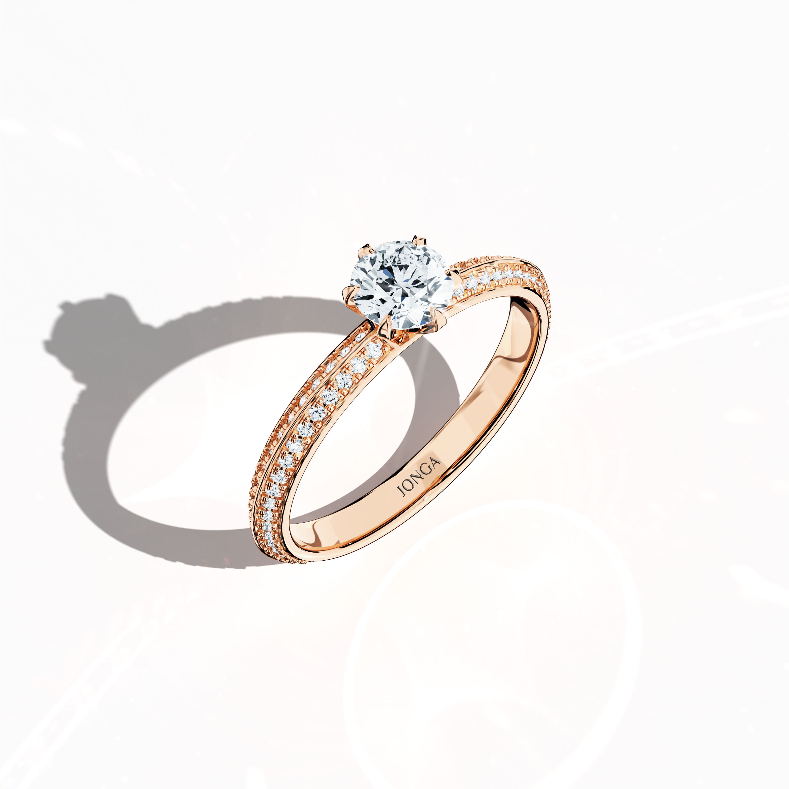Modern 0.90 ct solitaire paved ring featuring a 0.50 ct center diamond and 0.40 ct pavé side stones, set in soft rose gold (blush/pink gold) with a dual‑tier, step‑designed band and a defined central line. Captured from a front top side angle, this fine jewelry/fine jewellery ring emphasizes its intricate pavé setting and gentle, luminous finish.