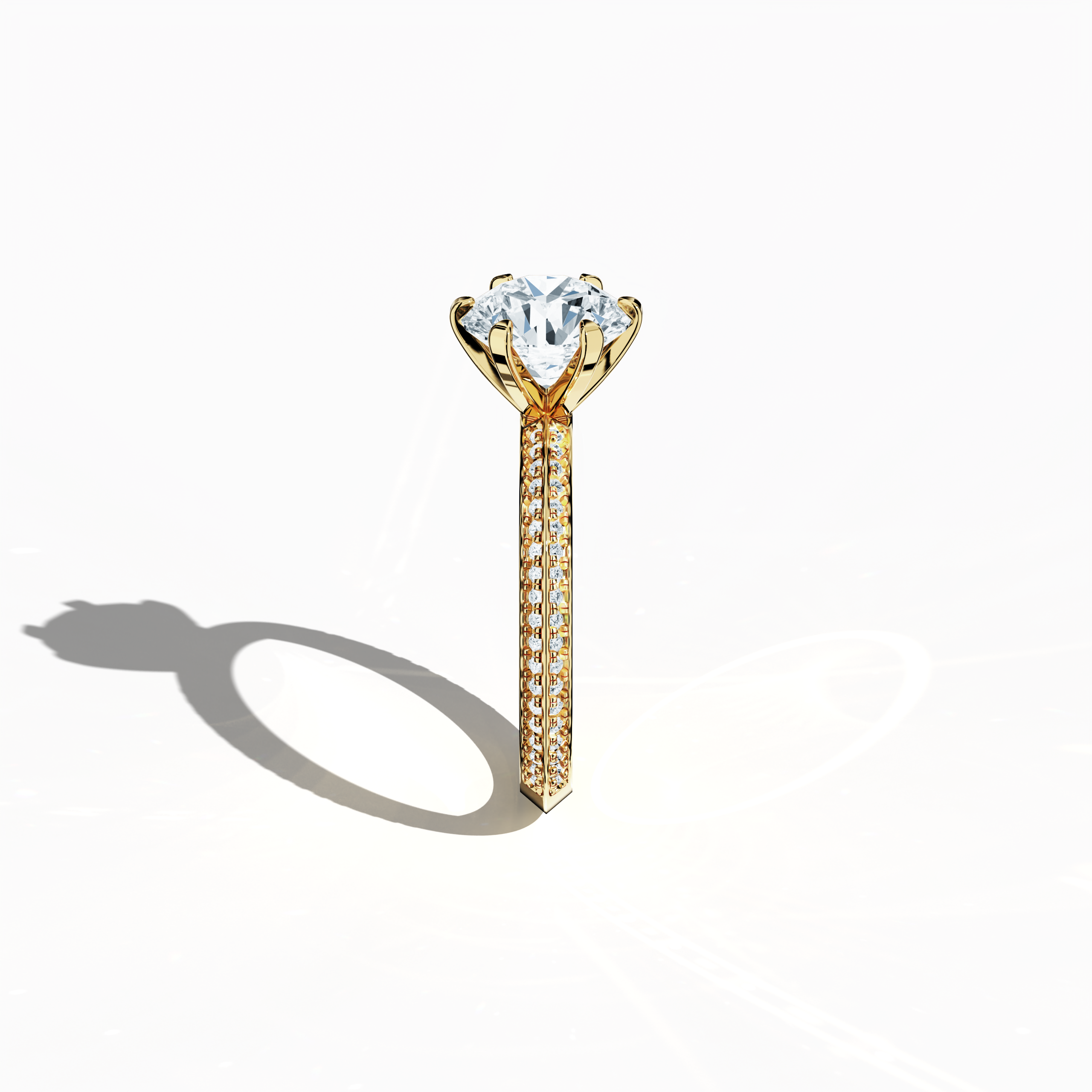 Refined solitaire paved ring with 2.40 ct total diamonds (2 ct center, 0.40 ct side stones) in a six‑prong baby claw setting and a two‑step band with a sharp central line, set in a rich yellow gold band. Photographed from a standing side view, this fine jewelry/fine jewellery ring showcases its elegant contours and vibrant, warm finish.