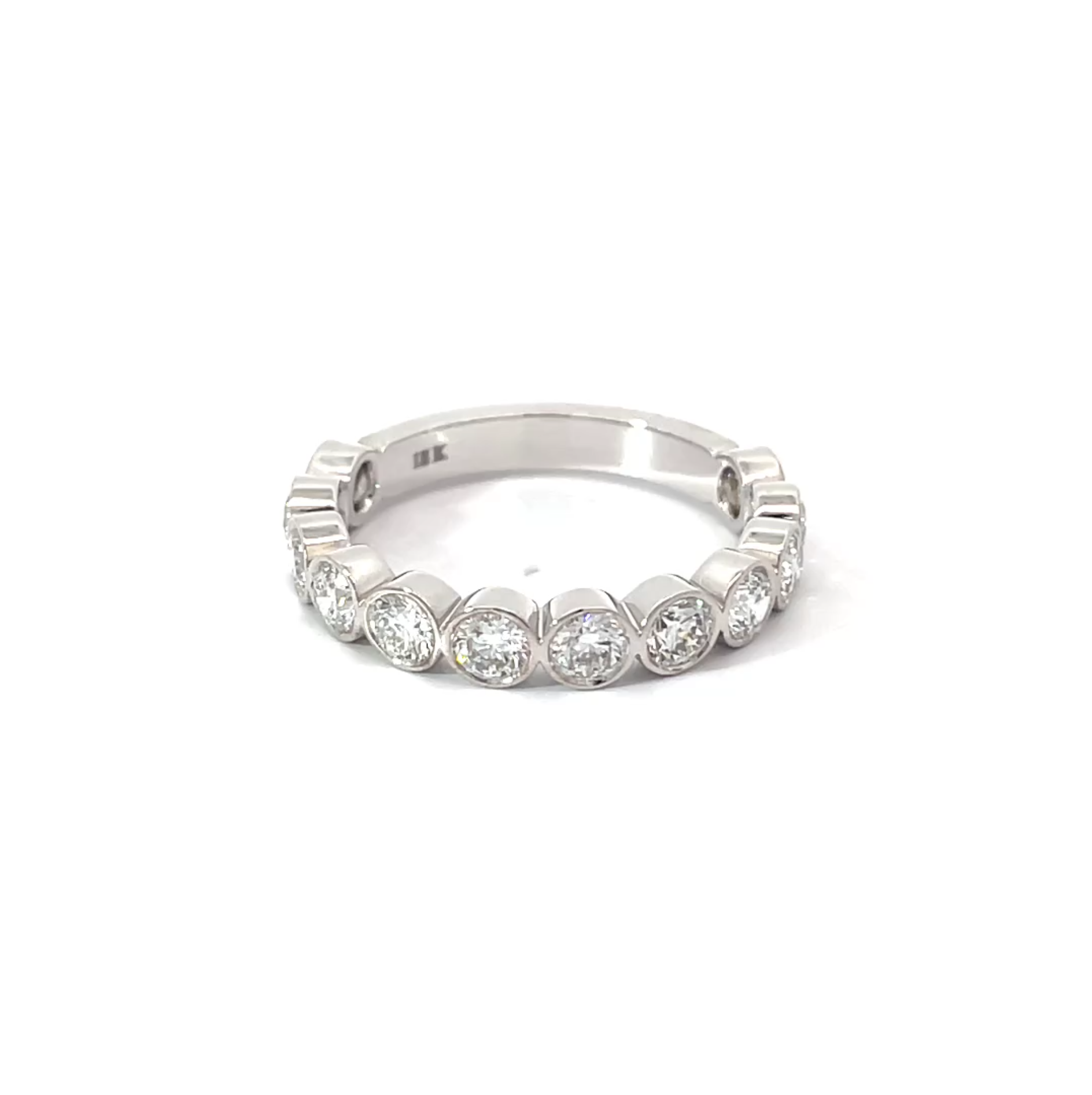 Bezel Band side view showing 1.30 carat D-F color VS clarity diamonds in bezel setting 18K white gold

