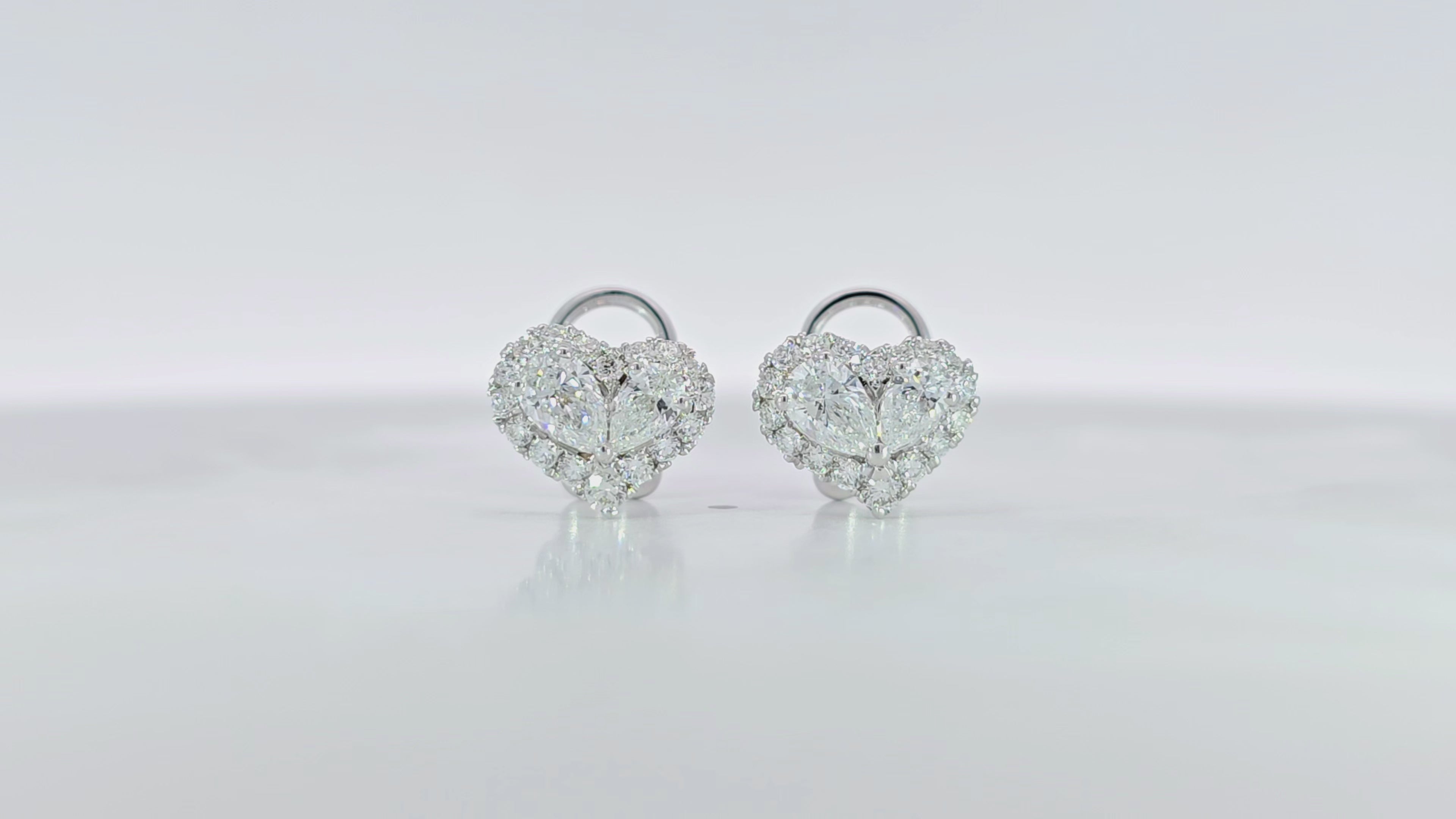 Heart shaped pear diamond halo Earring detailed video displaying heart halo setting and 0.84 carat side diamonds
