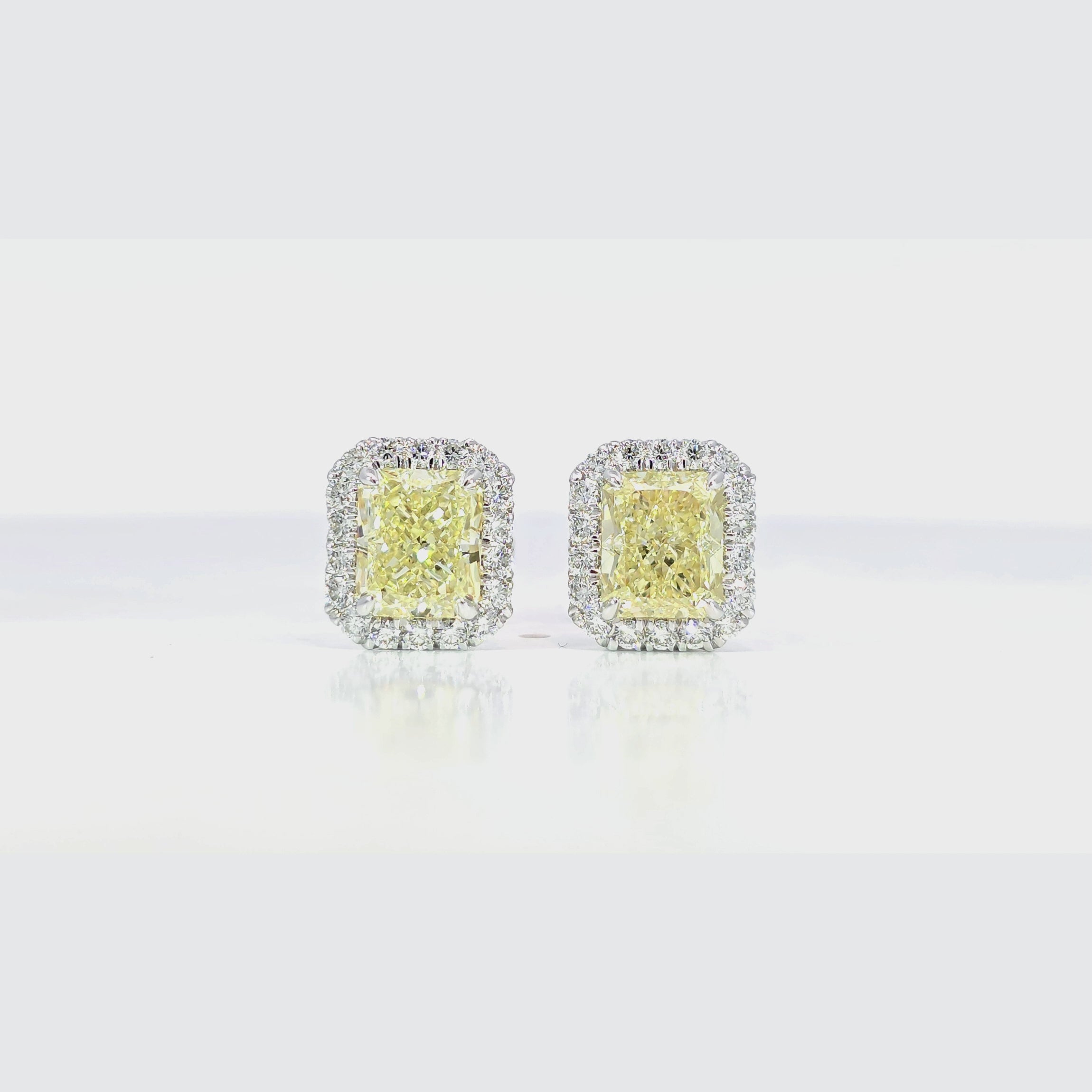 Yellow Radiant Diamond Halo Earring 45 degree video showcasing 3.01 carat Y-Z color center diamond
